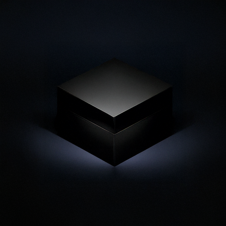 A black box with a matte finish placed on a dark surface, illuminated by soft lighting.