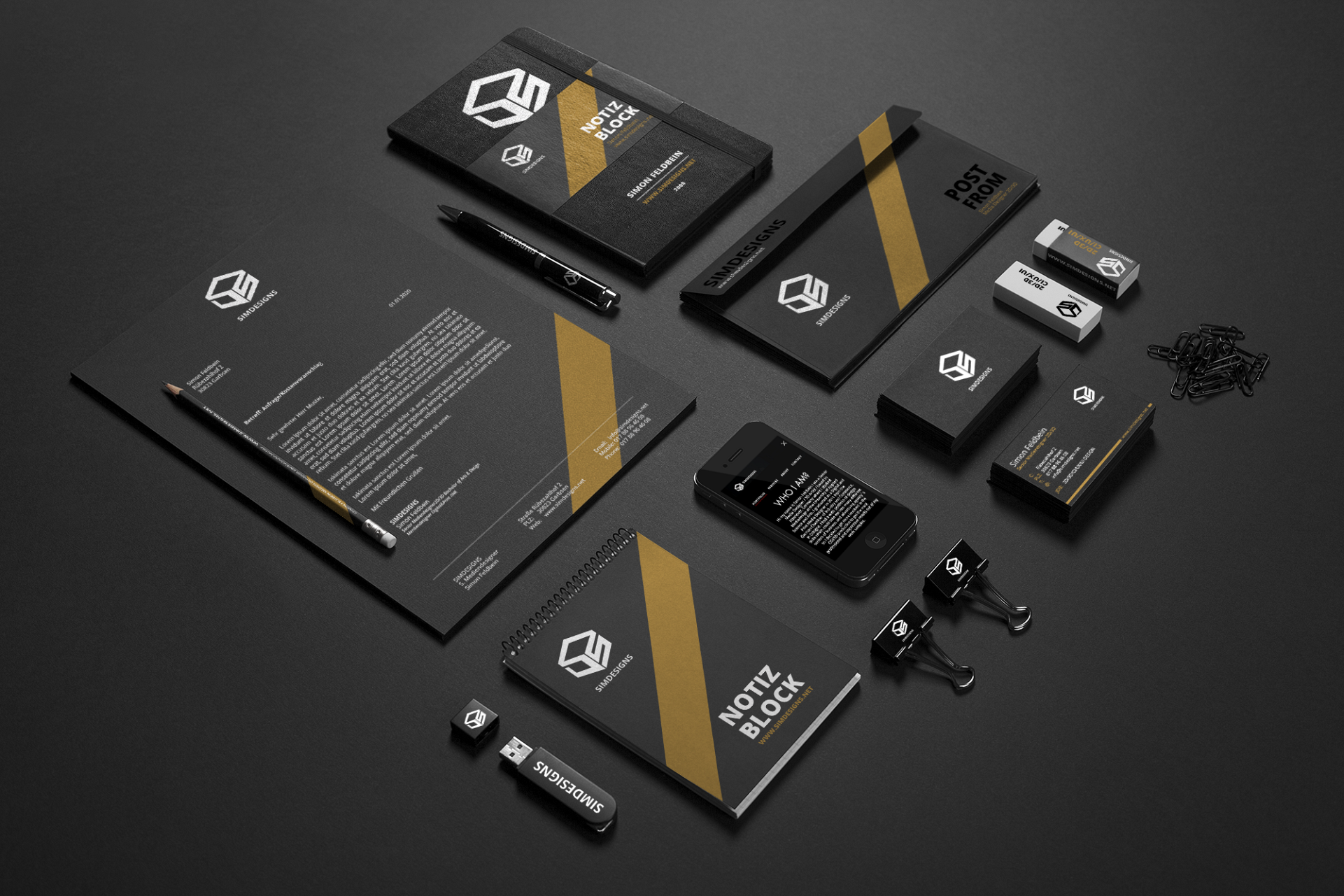 Branding and stationery items for SMIDesign, including notebooks, a USB flash drive, business cards, pens, erasers, paper clips, and a smartphone, all displayed on a black surface.