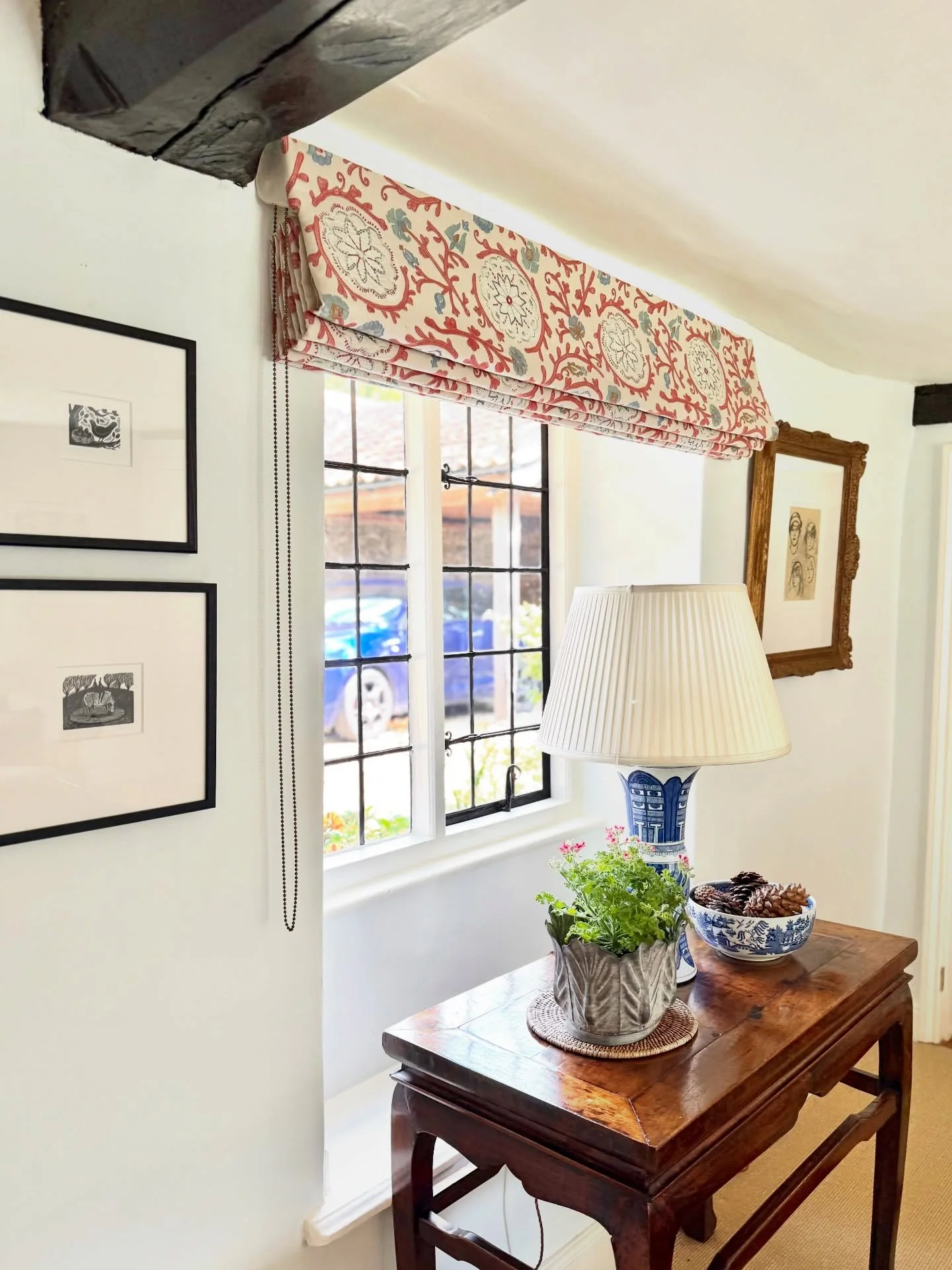 As though they&rsquo;ve always been there, our handcrafted Roman blinds in @colefaxandfowler Caspian Tomato blend seamlessly with our client&rsquo;s bounty of books and antiques. A perfect warm and timeless addition to this carefully considered home 