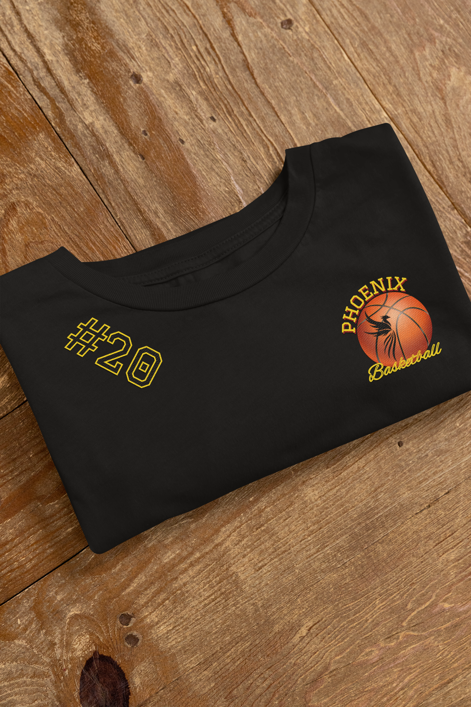 embroidered-bella-canvas-tee-mockup-featuring-a-wooden-surface-m33004.png