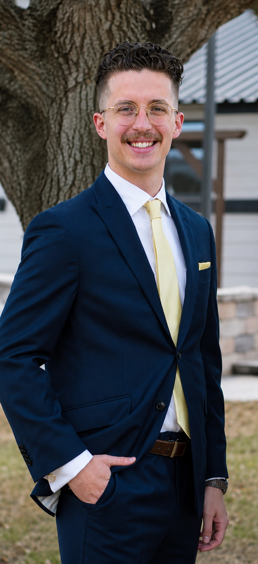 Jonathan Knott, insurance agent at Vogt Insurance Partners, smiling outdoors in a navy suit