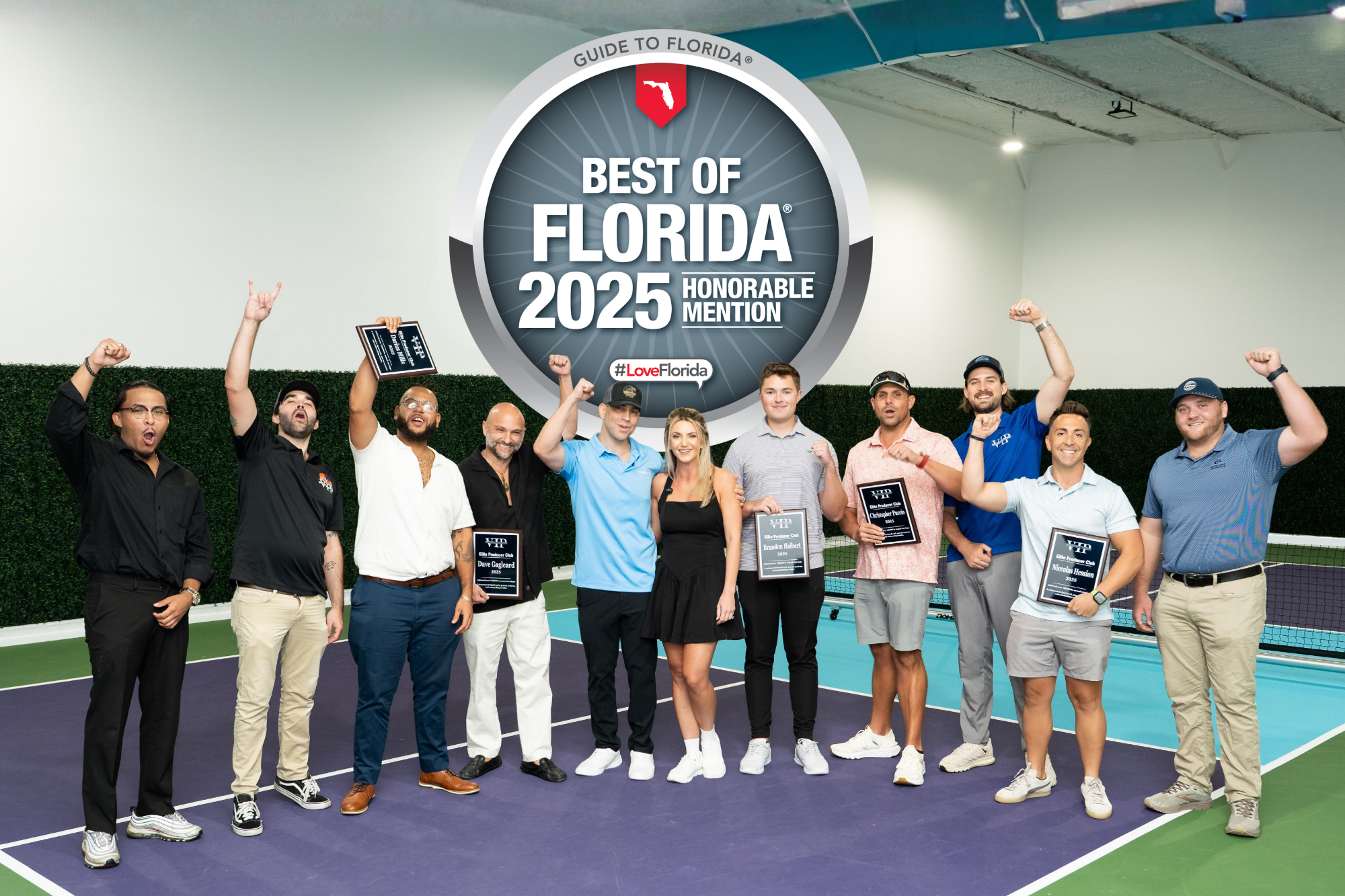 Best of Florida logo behind a team of agents, mostly men on a court wiht smiles holding awards