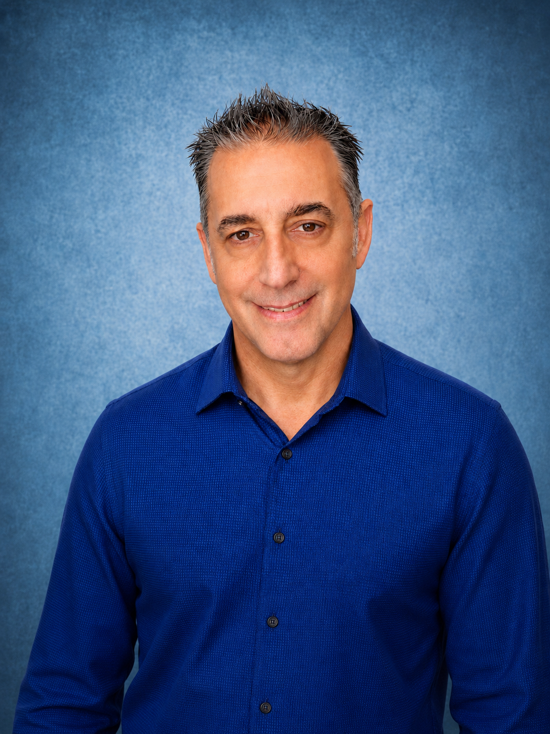 man in blue shirt posing professionally