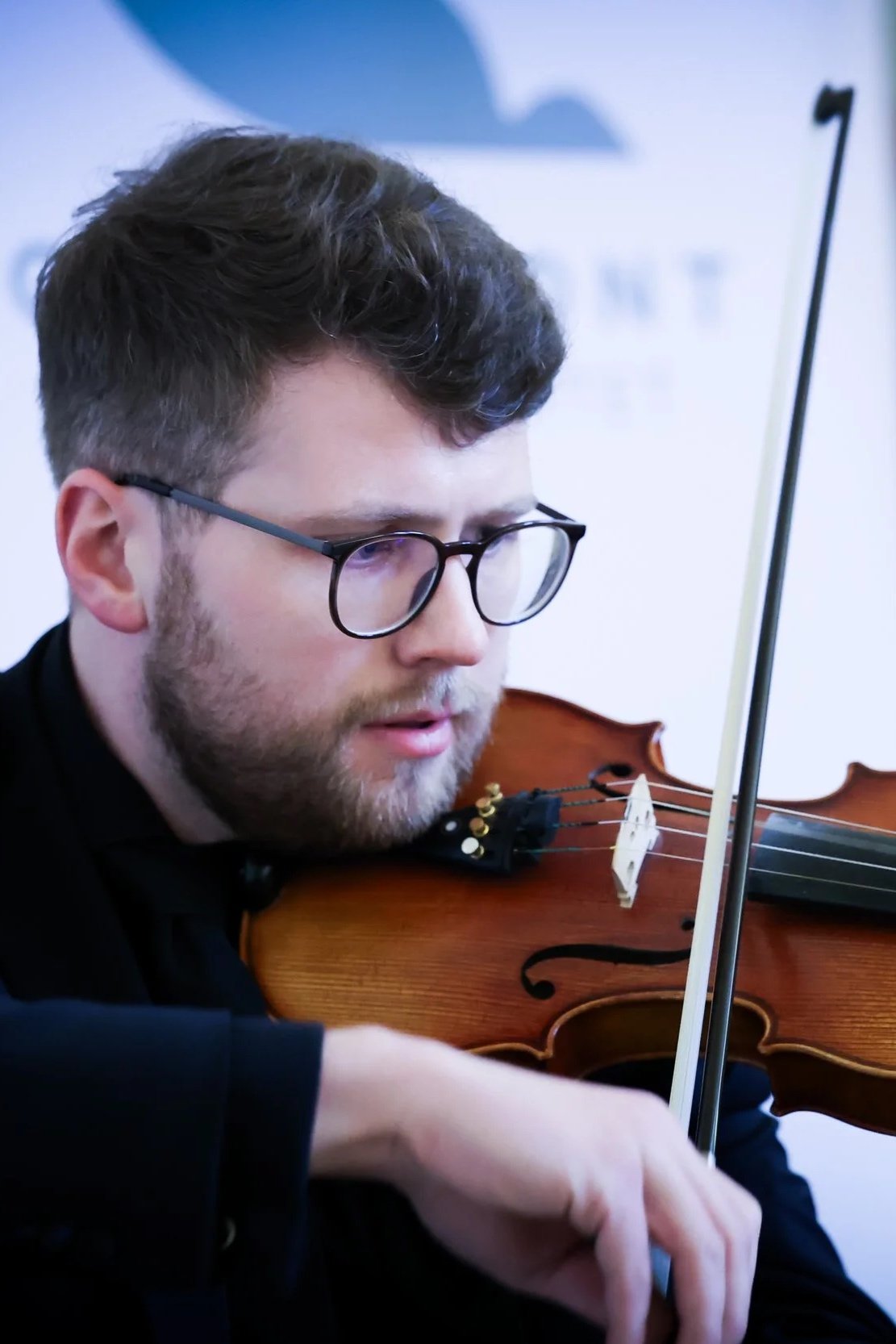 An image of Matthew Toal playing the violin