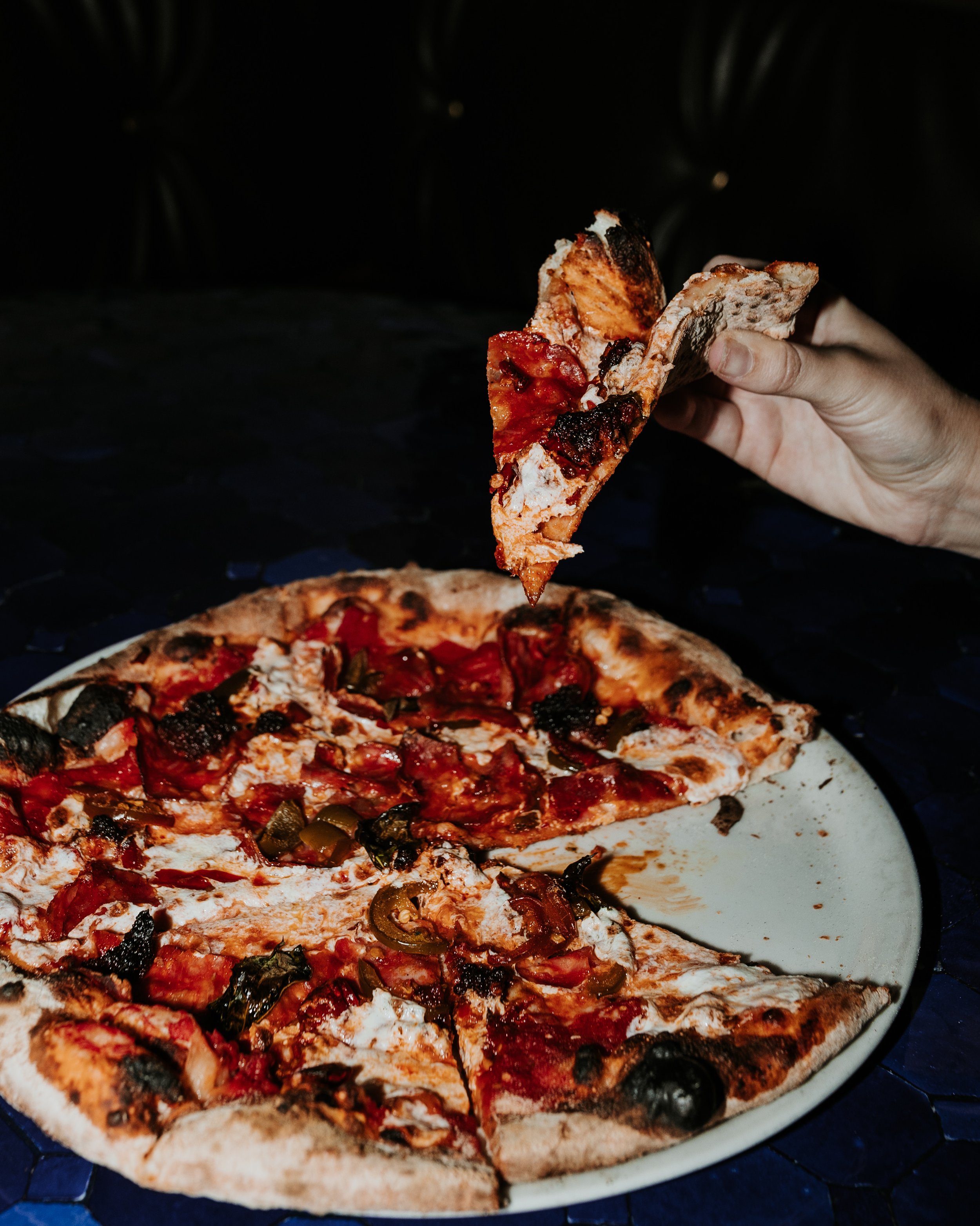 Holding up a pizza slice