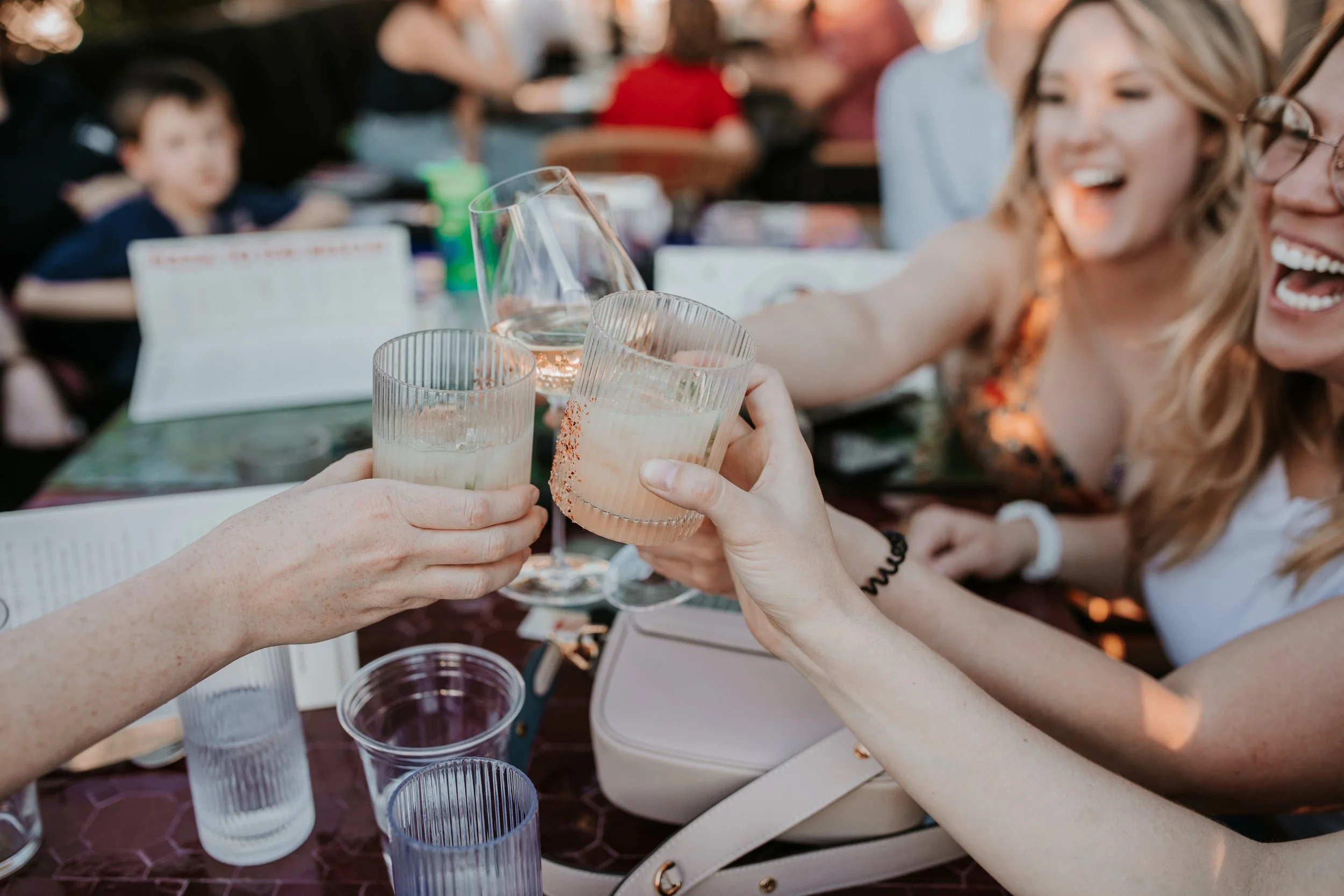 People enjoying cocktails on the patio for trivia night at Pizza To The Rescue