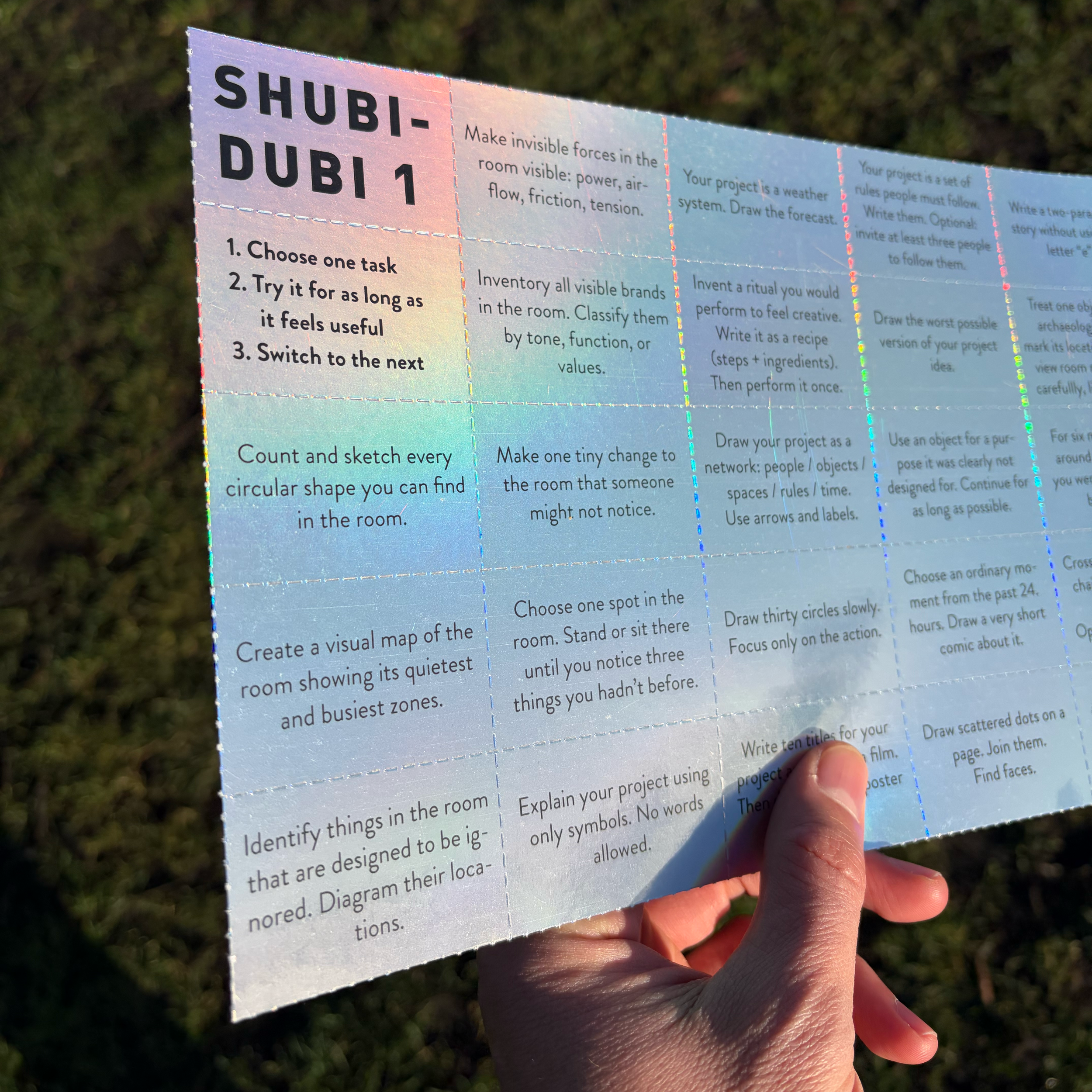 A torn Shubidubi sheet, one instruction per strip, ready to be taken and done.  Shubidubi tasks printed as small cards and receipts, left to be picked up.