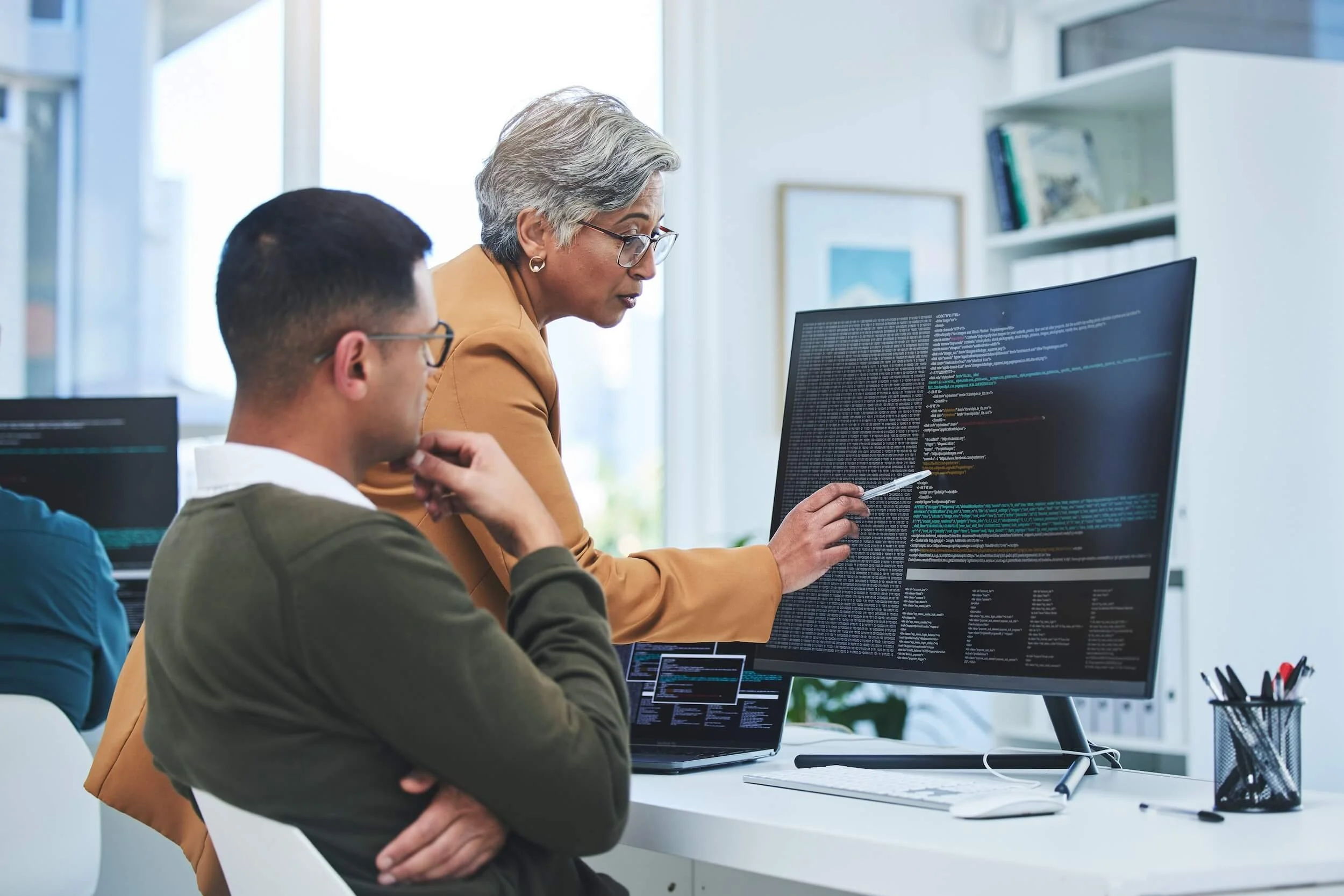 Two employees reviewing security vulnerabilities