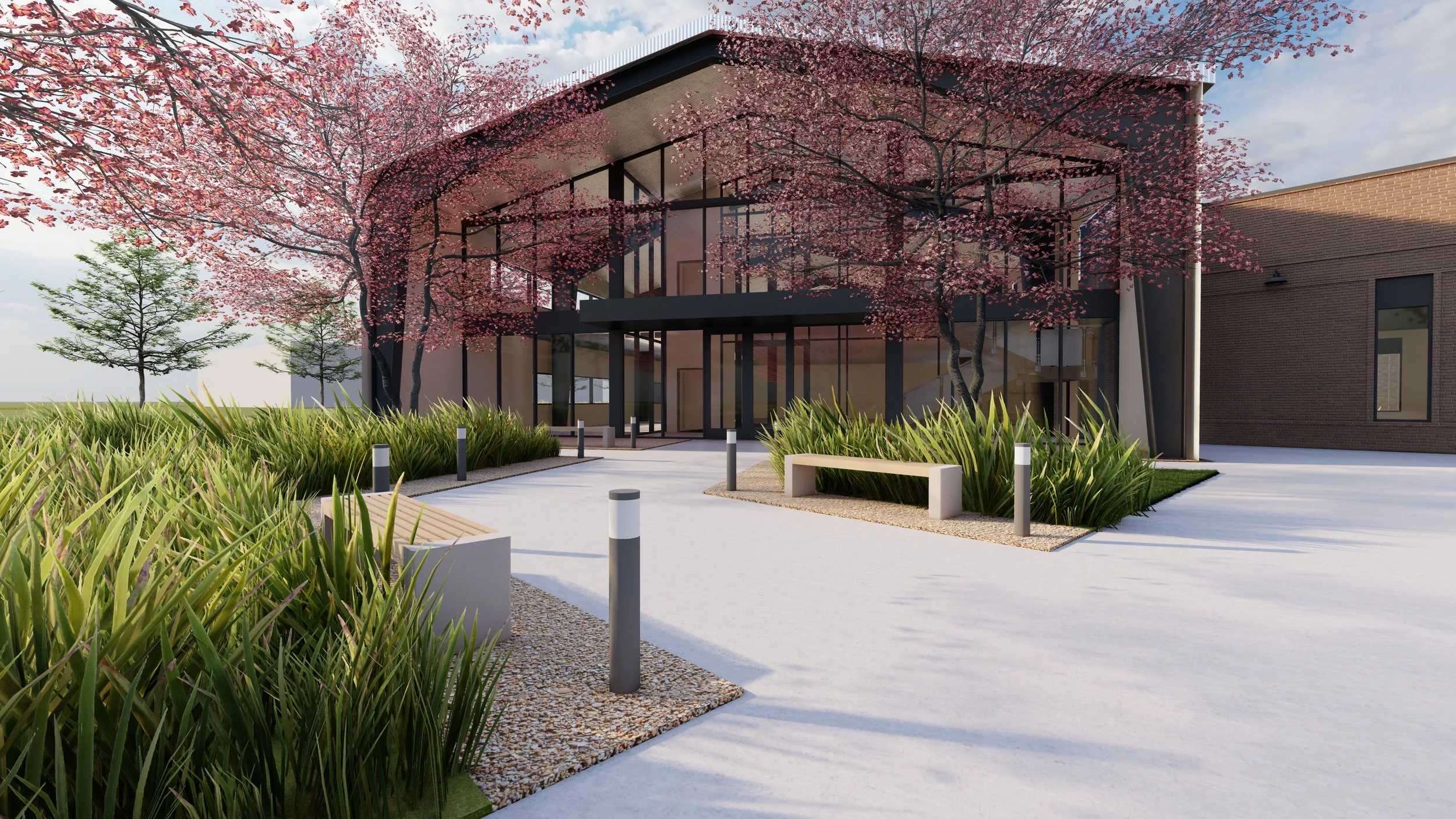 Modern building exterior with large glass windows, surrounded by landscaping with pink blossoming trees, green bushes, and benches along a pathway, apartments, home