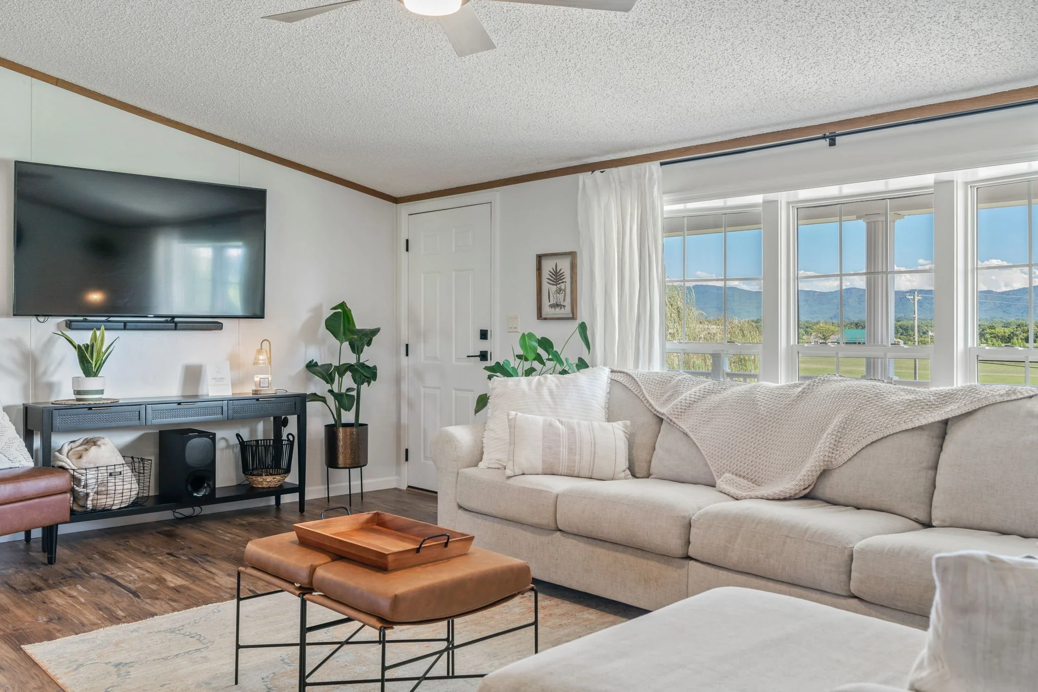 Cozy sectional sofa in the living room with flatscreen tv and a view of the mountains.