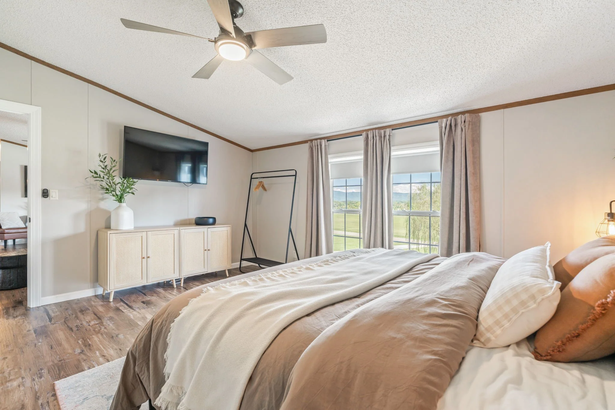 Comfortable king bedroom with natural light in East Tennessee rental near the Smokies