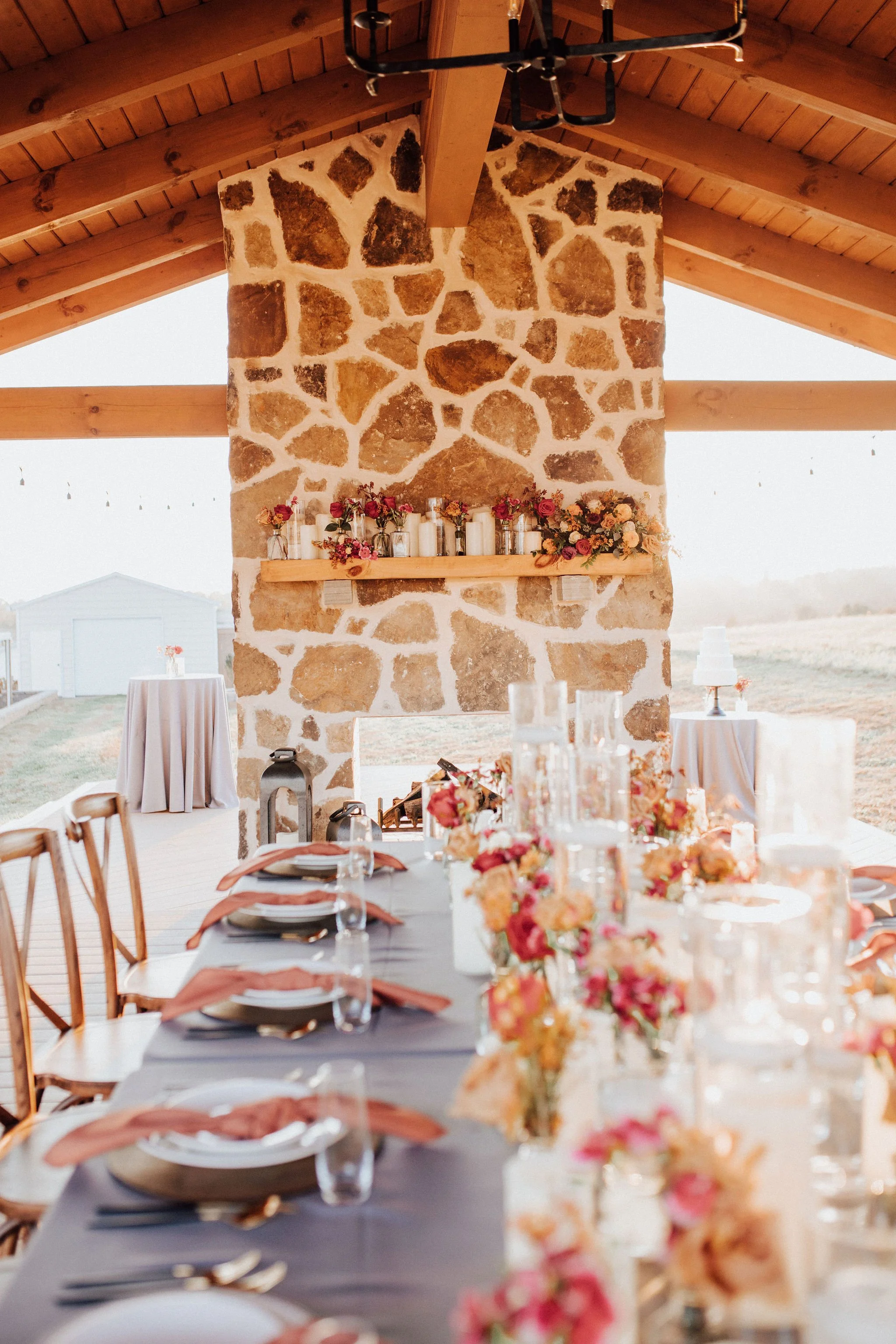 Wedding Venue with stone fireplace and fall florals.