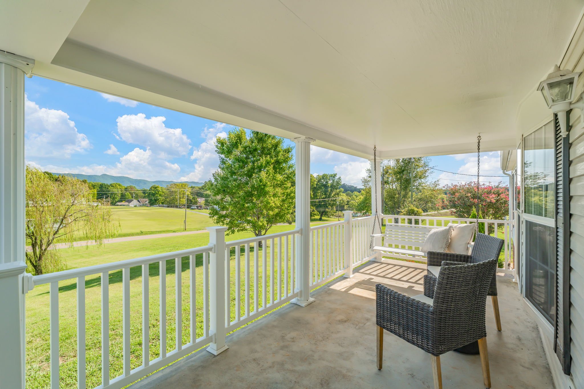 Covered front porch with scenic Smoky Mountain views and peaceful countryside setting