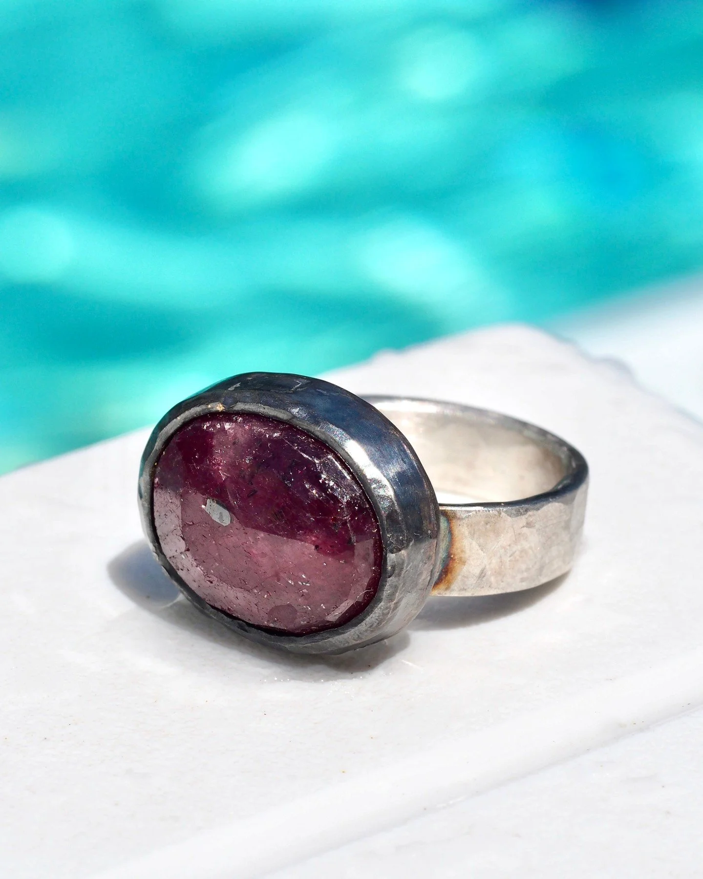 Customer's own ruby with a custom setting and band made to match the stone. Bold and chunky with an oxidized recycled sterling silver bezel, hand chiseled and a semi-matte hand-formed band, also in recycled sterling, but without the oxidation. Seen h