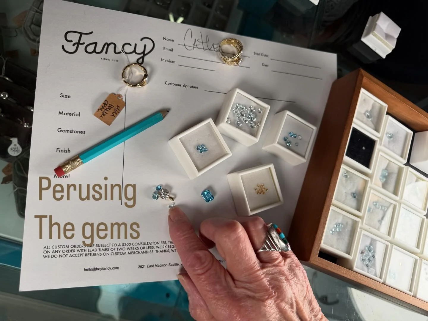 Step 1 in a Fancy consultation&mdash;we&rsquo;re building something beautiful together. Cathea brought in her own diamond and lots of ideas. We picked out some sparkling blue topaz stones to go with it and a wee diamond too. She loves gardening and n