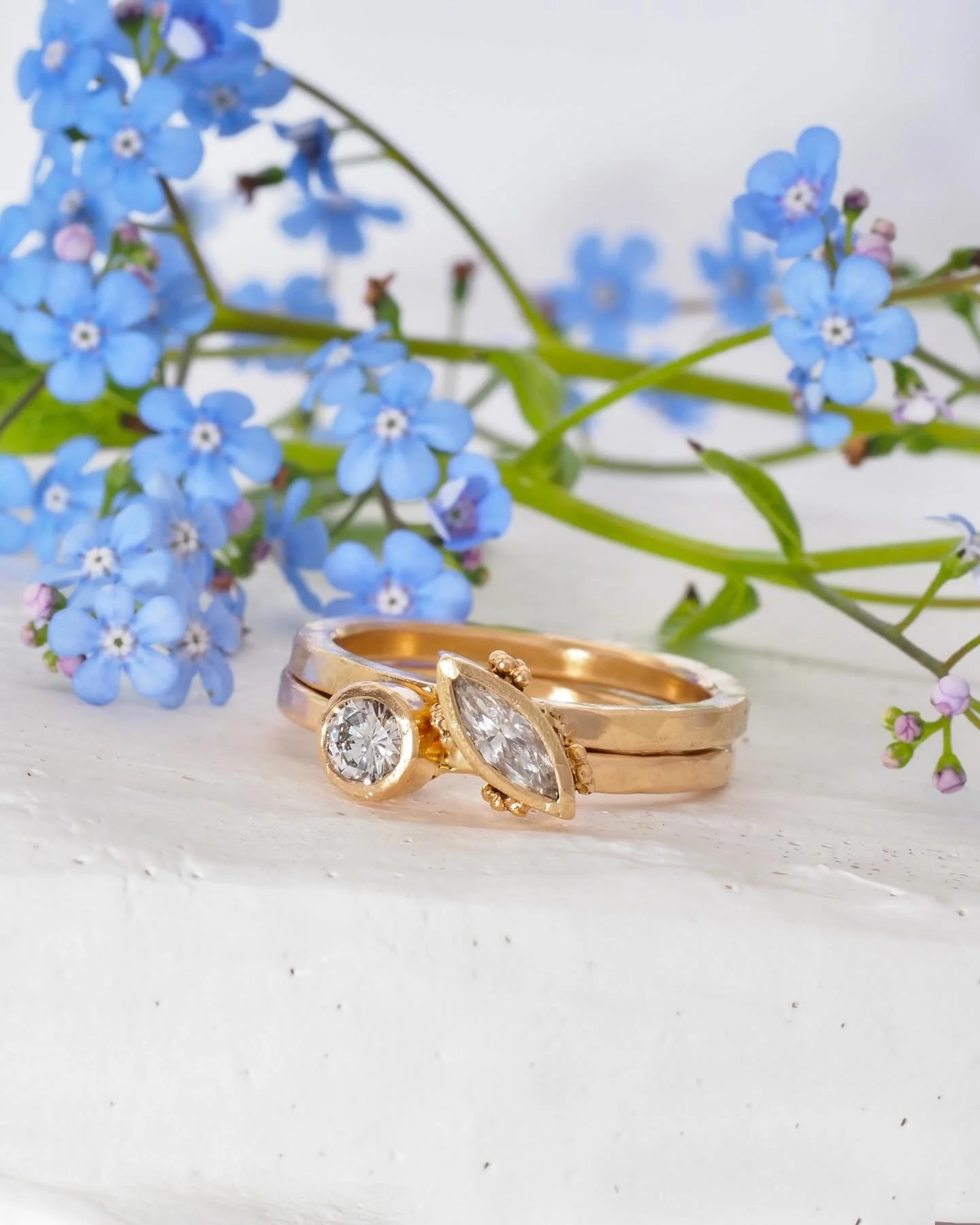 Bespoke ring set, designed using the client&rsquo;s gold and diamonds from older jewelry. There&rsquo;s more in this set that we&rsquo;ll share later, but the forget me not flowers in the background have us thinking about remembering to be gentle wit