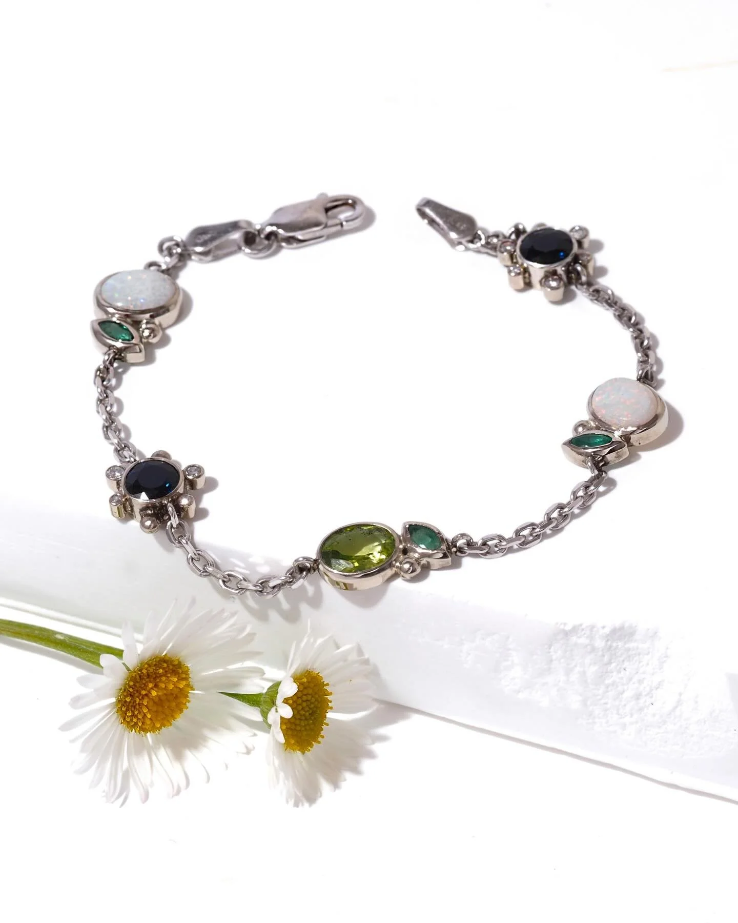 Bespoke bracelet with a floral inspiration. Bezel set gemstones in recycled sterling silver.