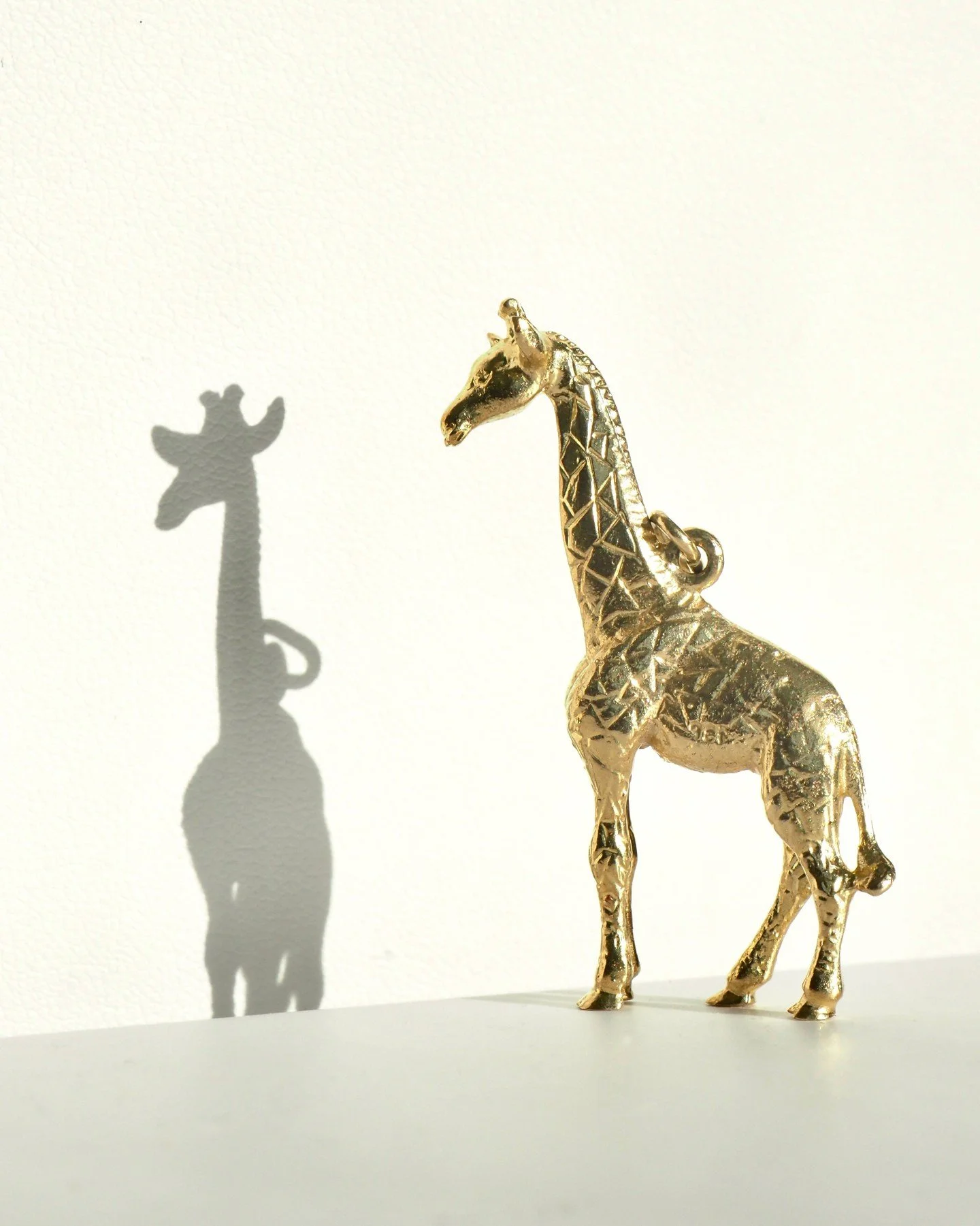 And now for something completely different! A vintage giraffe pendant. It stands tall at about 1.5 inches and is well balanced. This gold giraffe is part of our eclectic vintage estate jewelry collection -- we've got some really incredible pieces in 