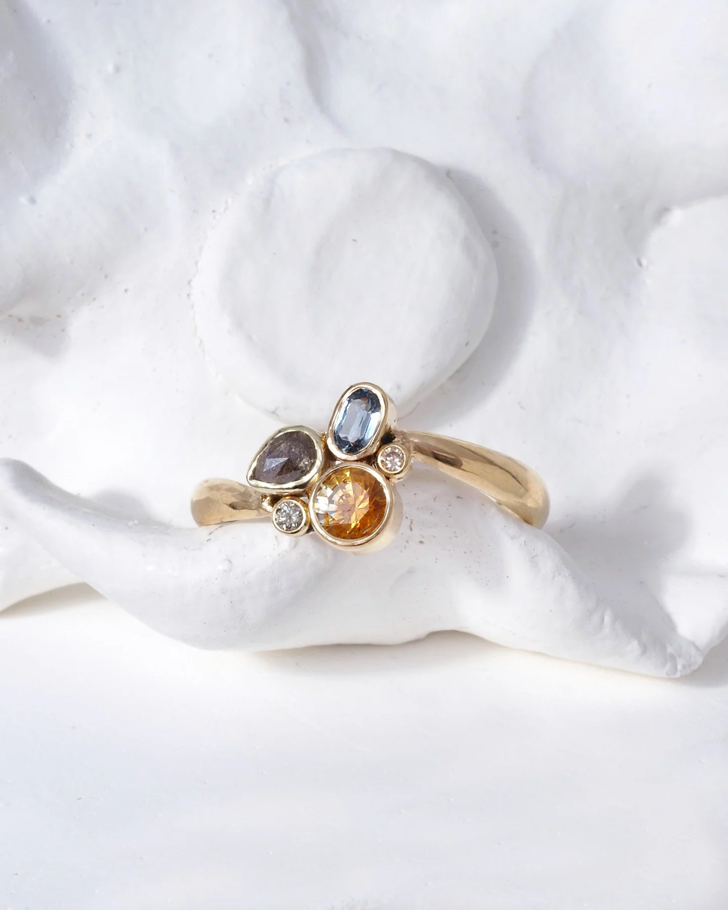 Bespoke ring with a glossy high/low band in recycled 14K yellow gold. Especially designed and fashioned for one person. Sally, Mira, and the client put their ideas together and came up with this pretty piece of joy.