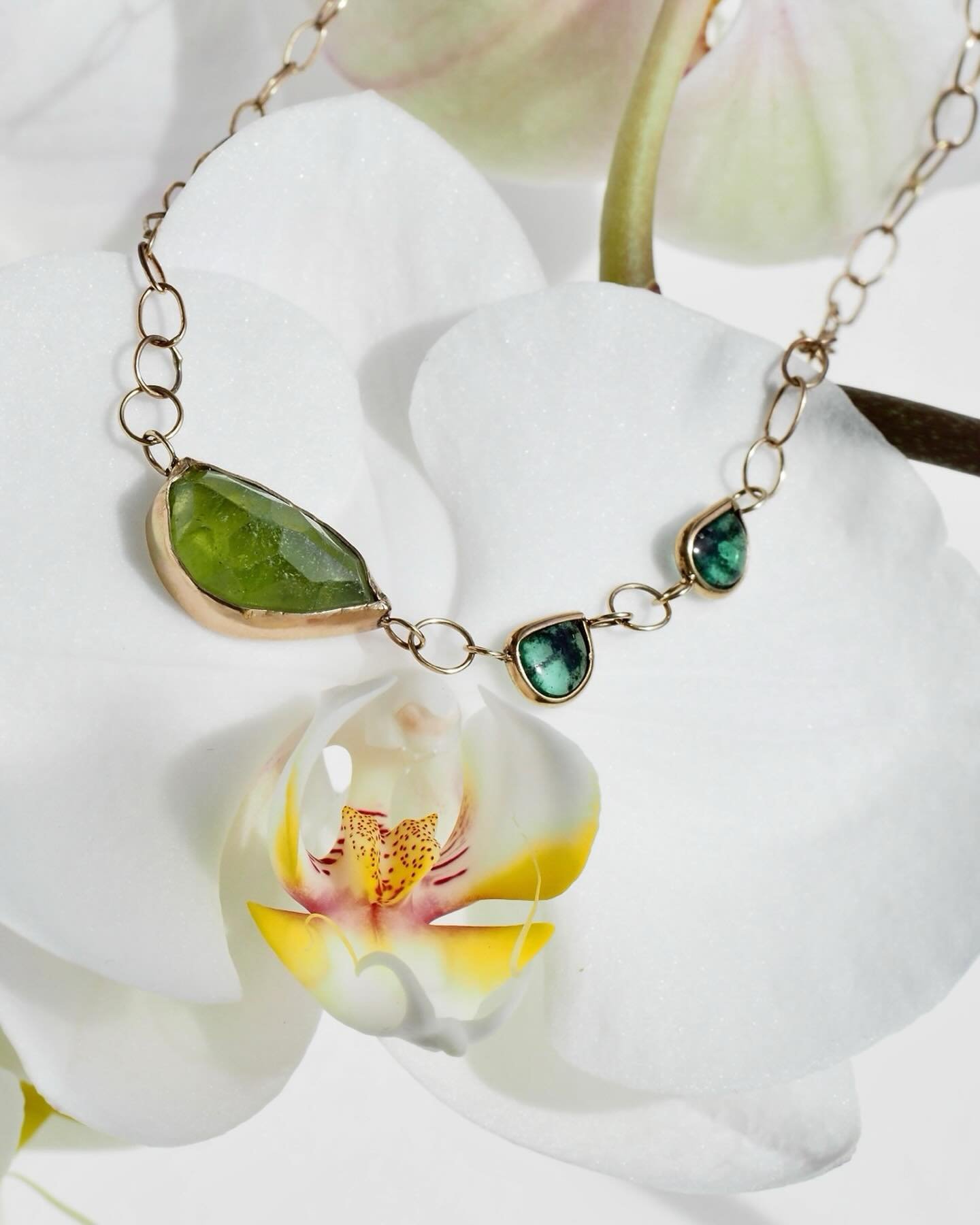 This special necklace was designed and built around three glowy green gemstones with unusual shapes. Sally bezel set them and hand fashioned the links for the chain that holds it all together using a custom mix of recycled gold. #Green #MadisonValley