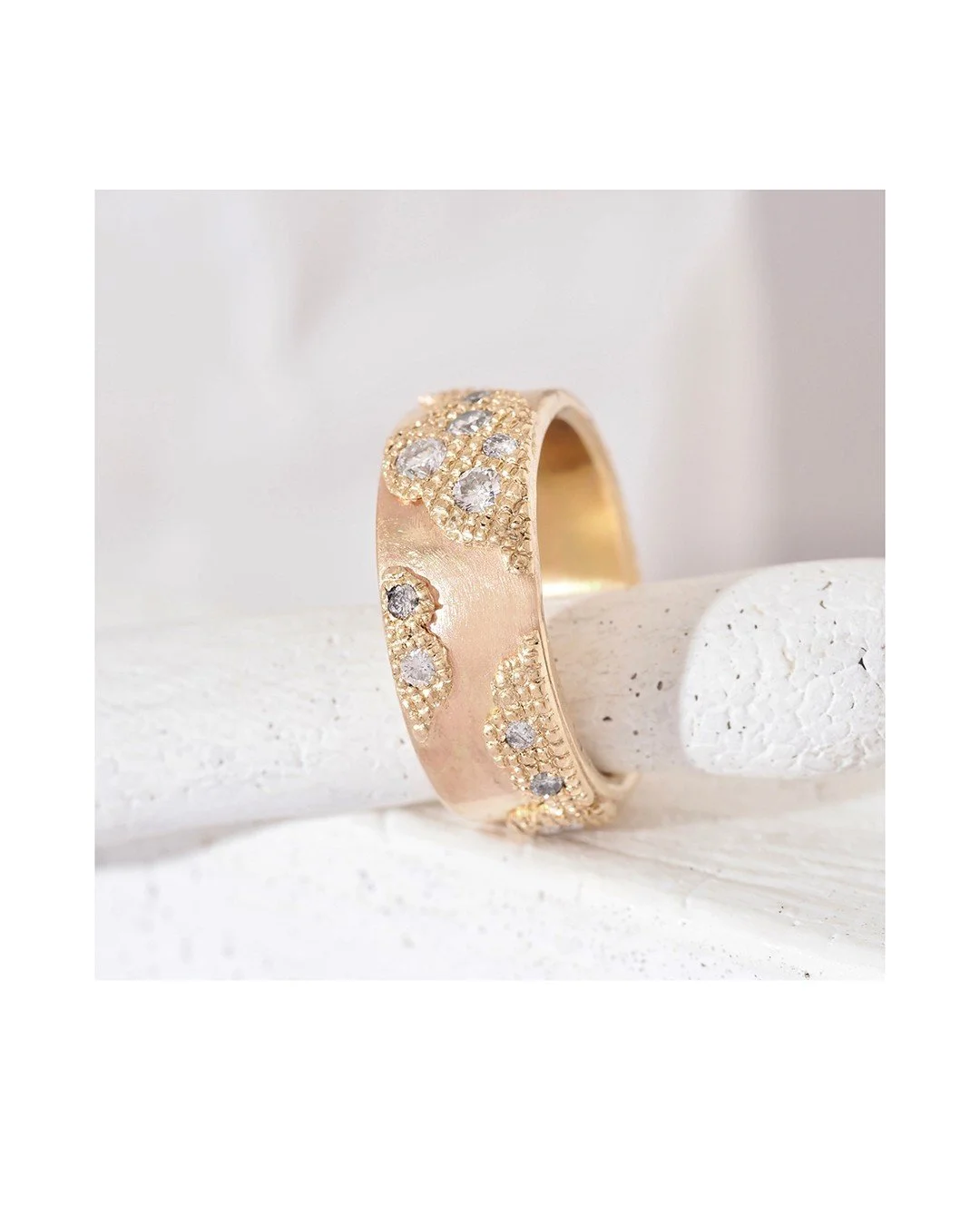 Patty's ring with hydrangea-inspired texture in the band and misfit diamonds sparkling from the textured portion. The rest of the band is glossy smooth in a custom mix of recycled gold. The design goes all the way around the band so no matter how you