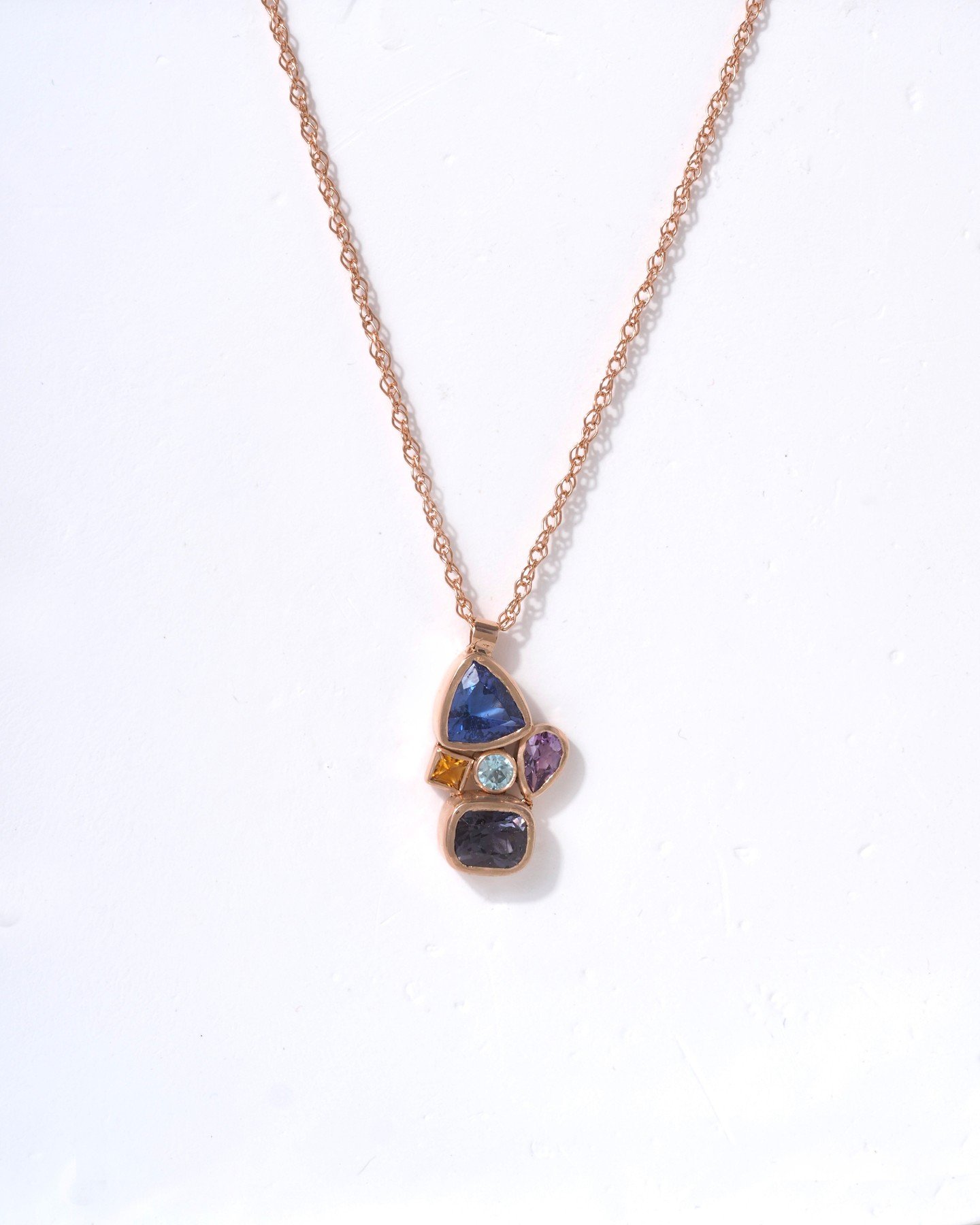 Custom multi-gemstone pendant in recycled 14K rose gold. Perfectly imperfect, fully custom design... there can be only one! Obligitory Highlander reference. Picks up the light so prettily. It's a work of art, a wee sculpture, many thanks to our creat