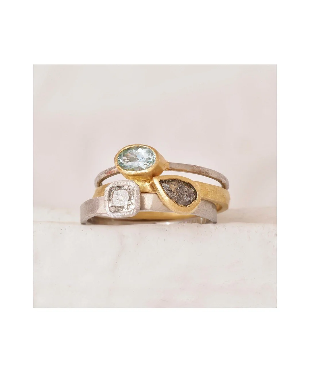 Aquamarine stack set... Aquamarine is the pretty birthsone for March. This set has a chocolate diamond and a white diamond. In recycled platinum and gold. The bezel around the white diamond adds to the sparkle and makes the diamond look more interest