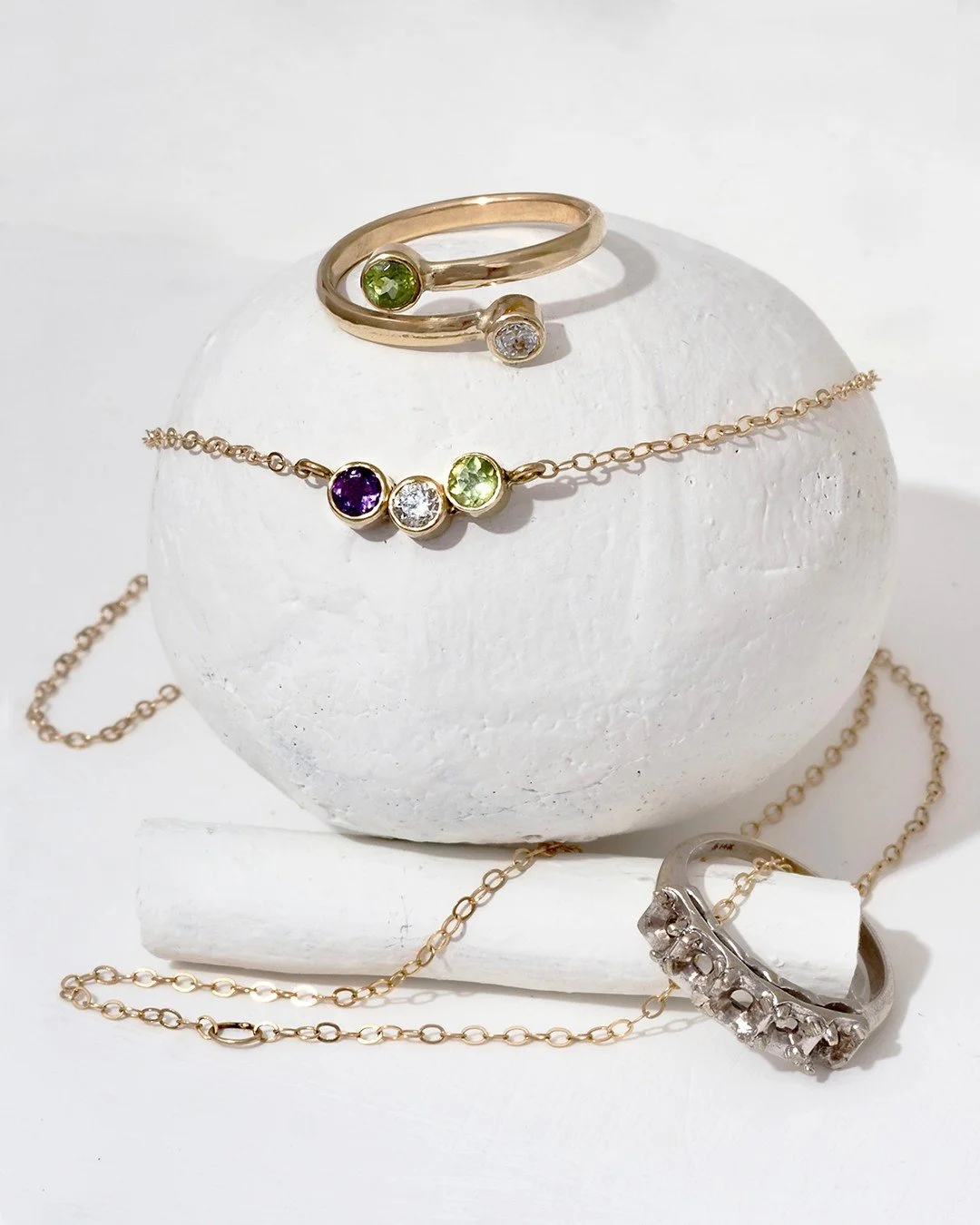 Fancy custom remodel of an estate ring, we carefully removed the stones in the ring (shown bottom right corner) and placed them in a darling necklace and a delicate high/low ring for a darling matched set.

#Renovation #Reno #EverythingOldIsNewAgain 