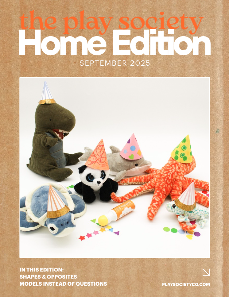 Cover of The Play Society Home Edition magazine, September 2025, featuring plush toys of a dinosaur, panda, shark, octopus, turtle, and gecko wearing colorful party hats, along with confetti and a glue stick.