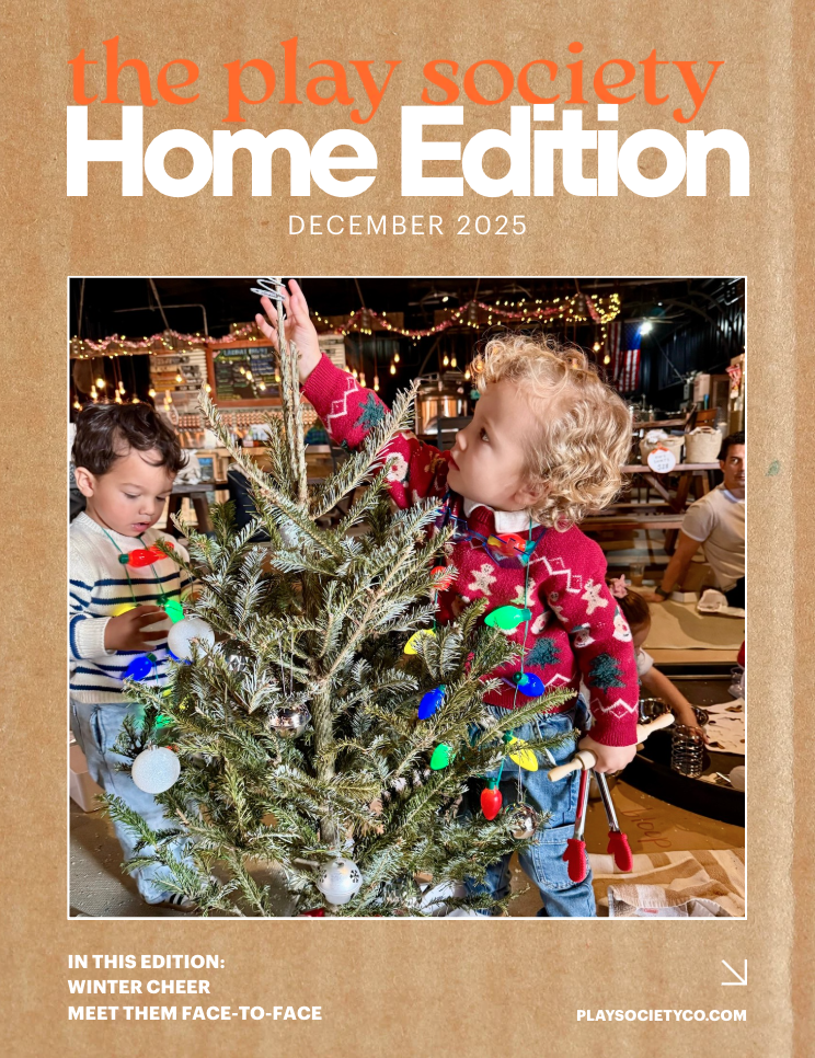 Children decorating a small Christmas tree with colorful lights and ornaments at a holiday event.