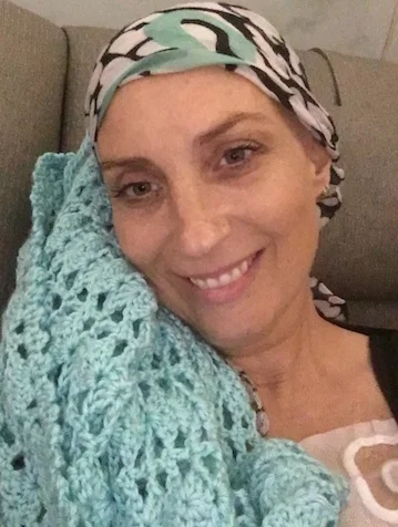 During a chemo treatment, before the eyebrows and eyelashes went, with one of the sweet prayer shawls made for me.
