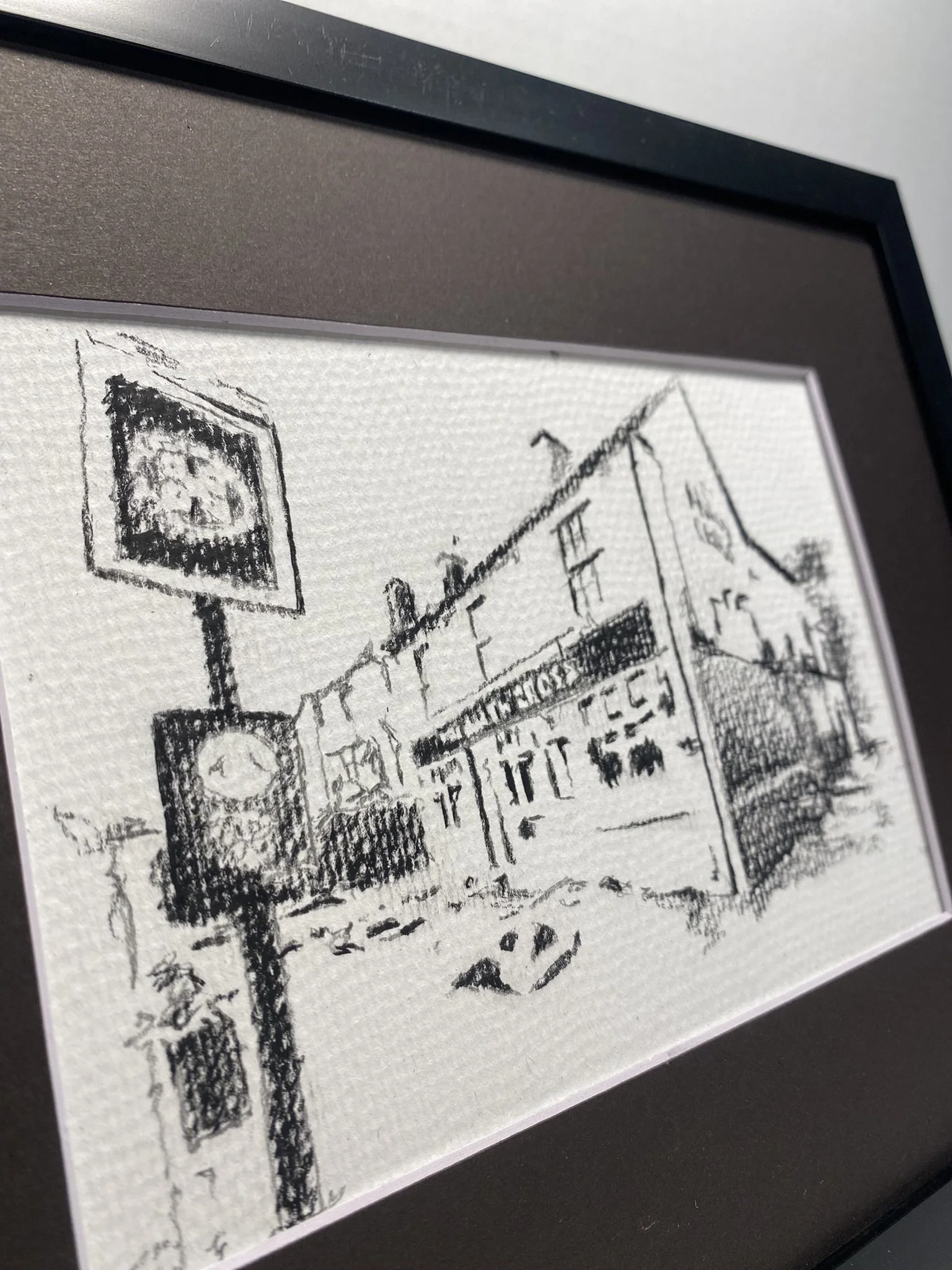 A black and white sketch of a city street scene with a large clock and a billboard, depicted in a minimalist style.