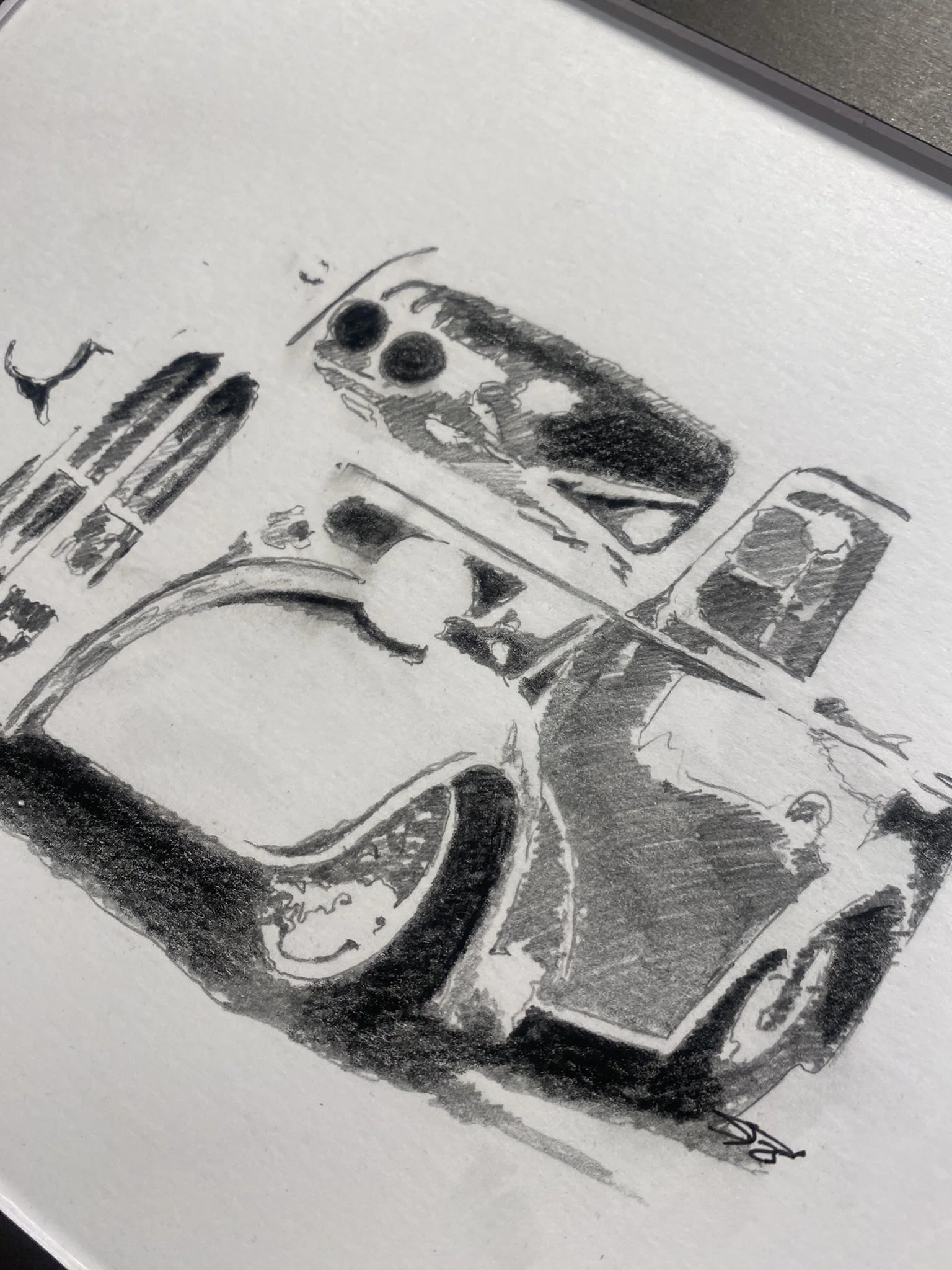 A detailed black and white pencil sketch of a vintage camera, showing the lens, buttons, and body with shading and texturing.