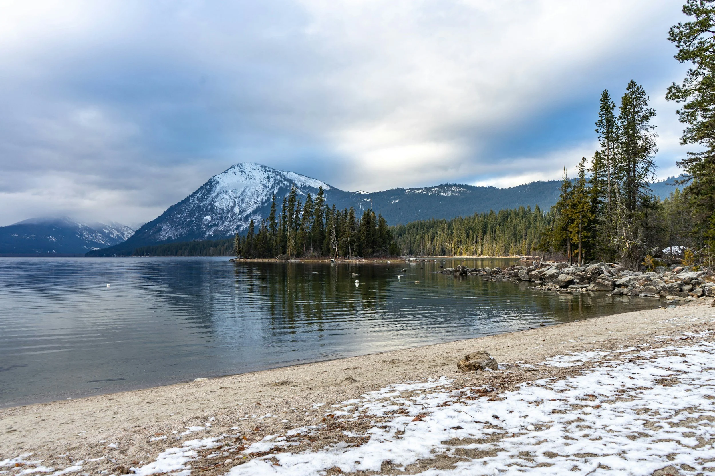snow capped mountain over lake