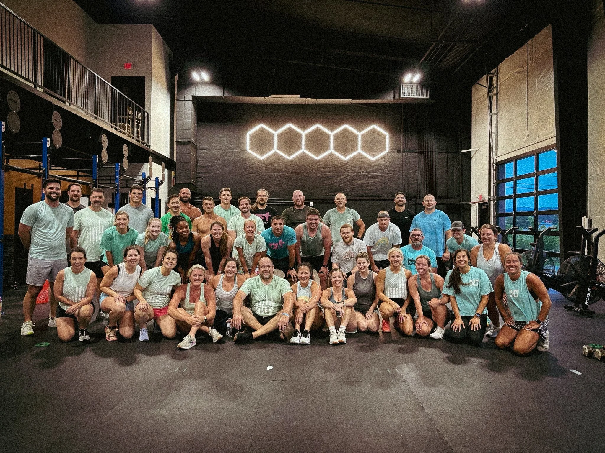 Smiling CrossFit Trussville members gathered for a team photo after a group fitness class in Trussville, Alabama