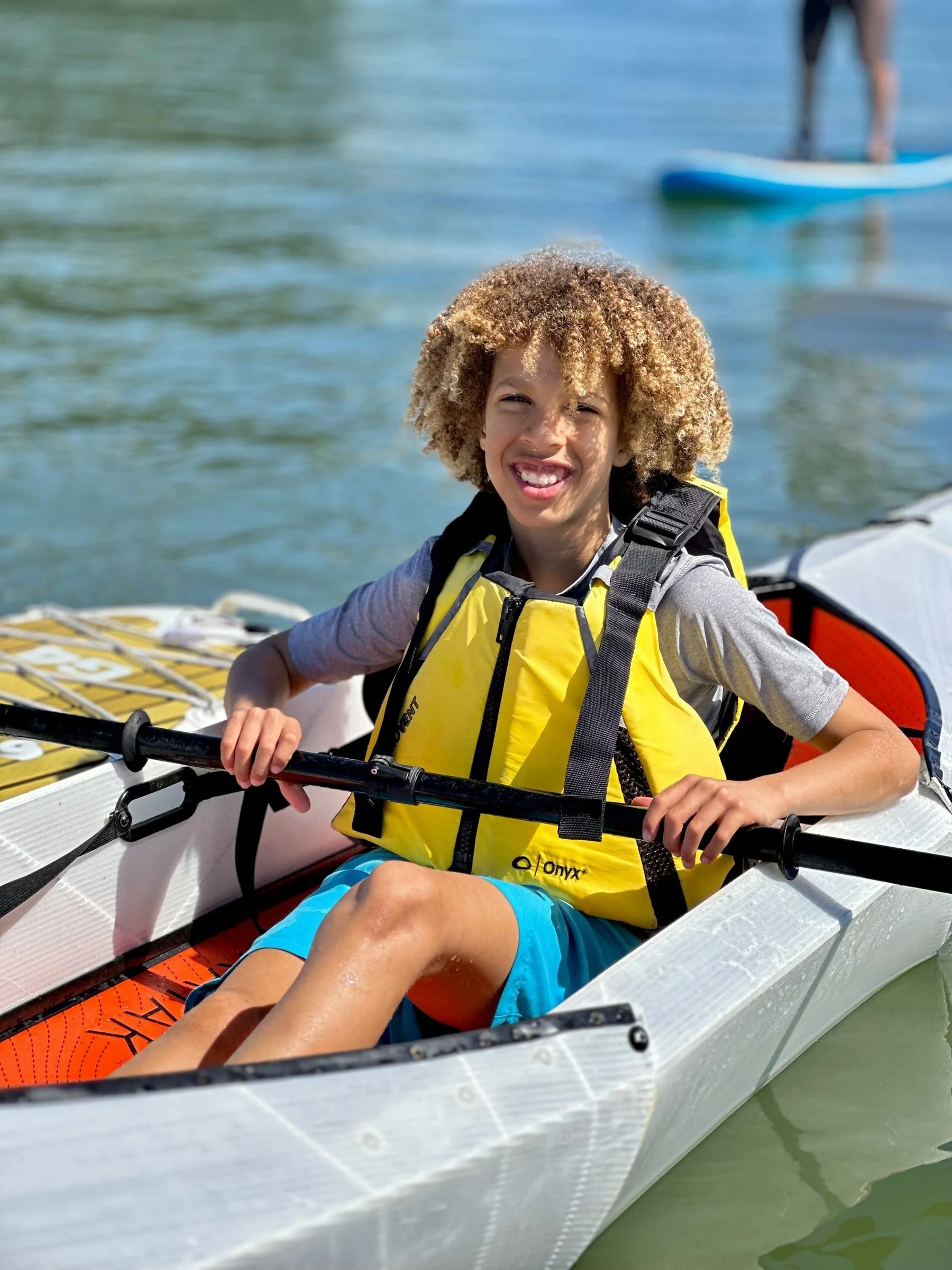 A camper kayaking on San Francisco Bay at intermediate SUP and kayak camp
