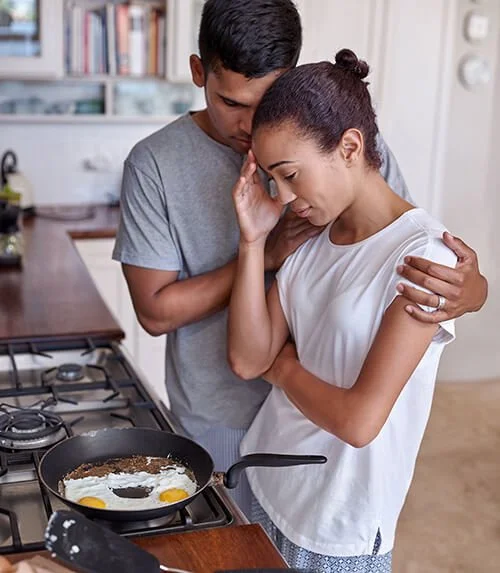woman feeling anxious while cooking breakfast