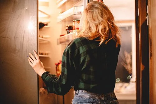woman feeling stressed looking in pantry