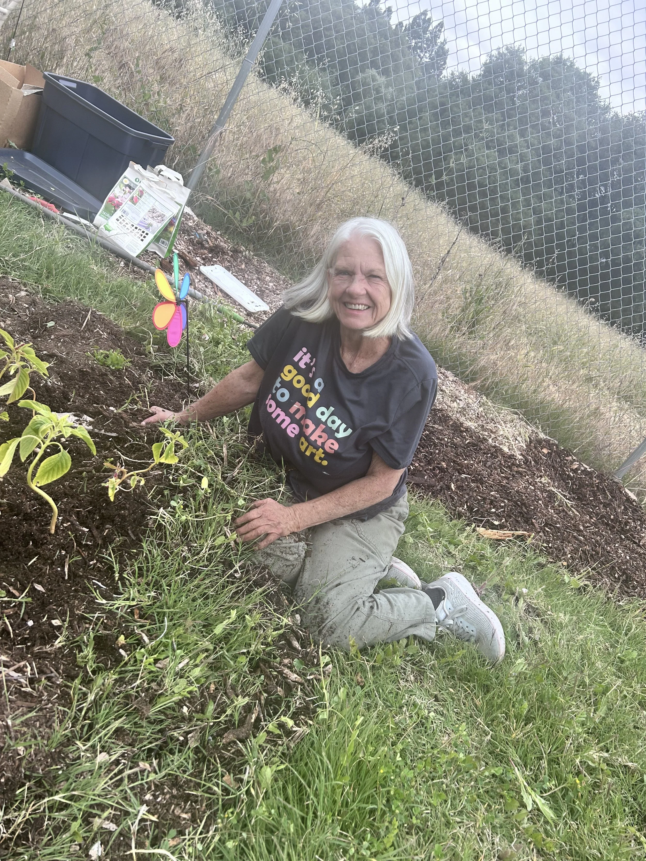 Hospice volunteer planting flowers at Amari Home Health and Hospice community garden