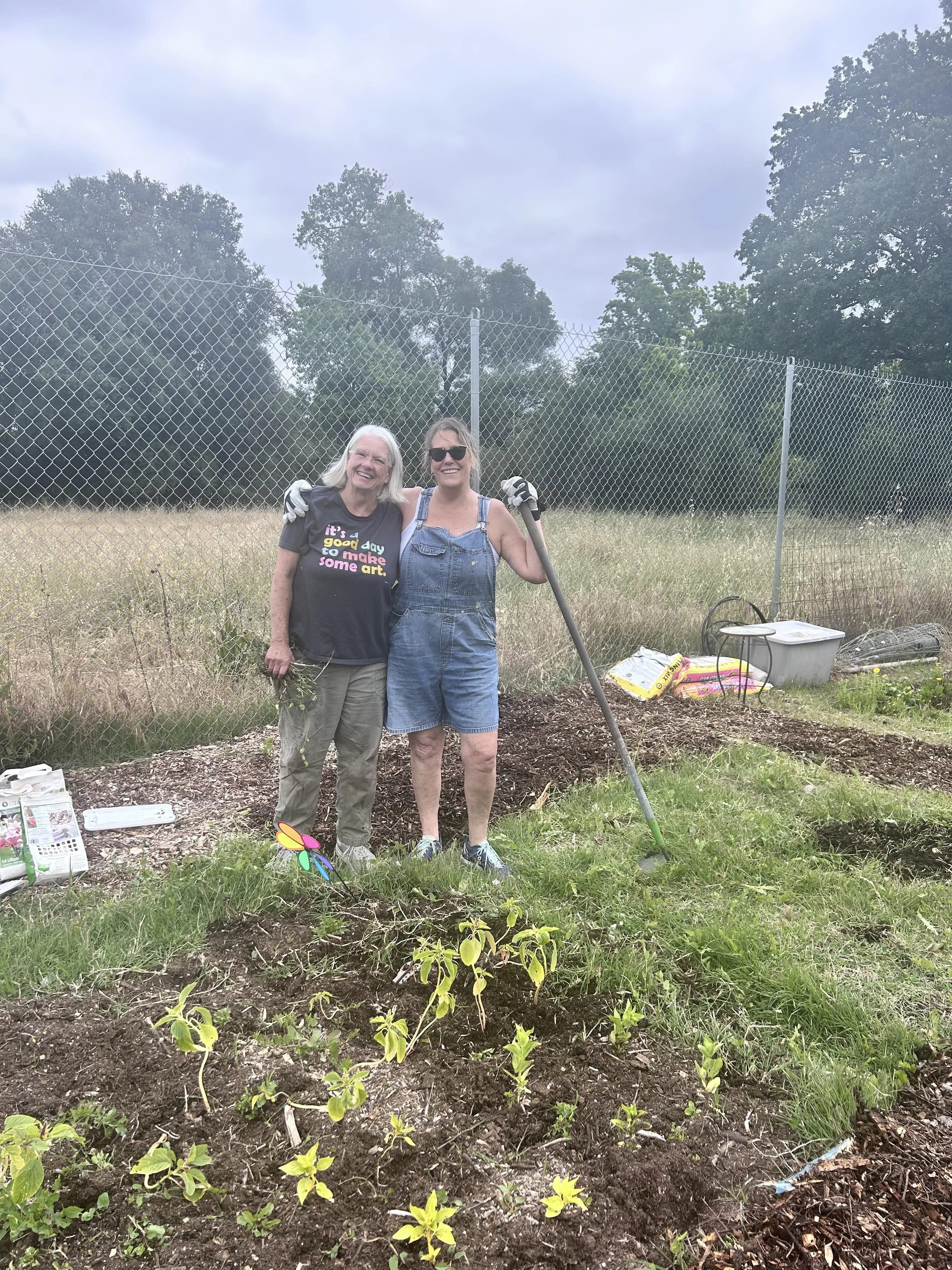 Amari Home Health and Hospice team members working in community garden with newly planted flowers