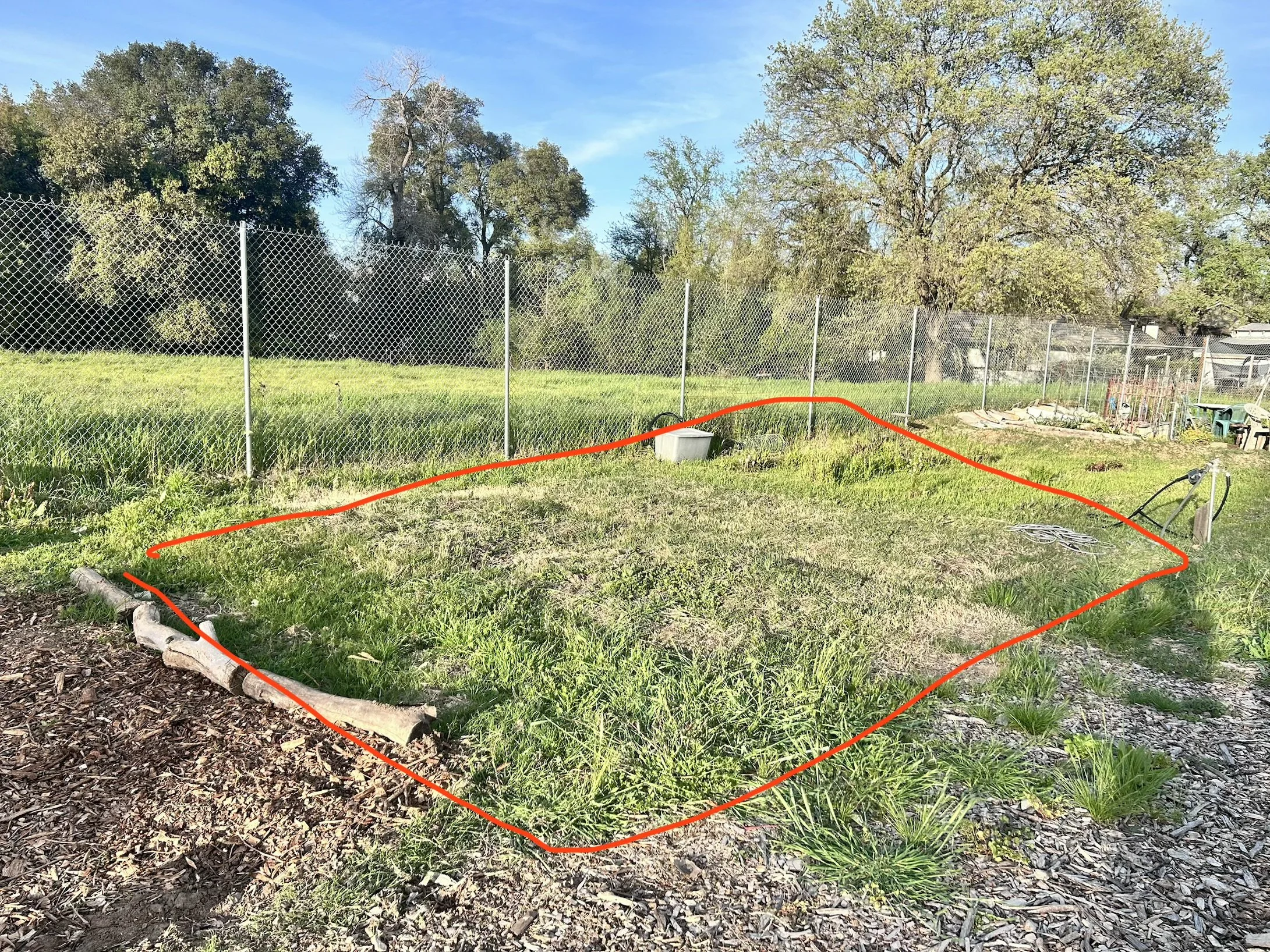 Perimeter boundary of Amari Home Health and Hospice community garden plot showing designated space before preparation and planting
