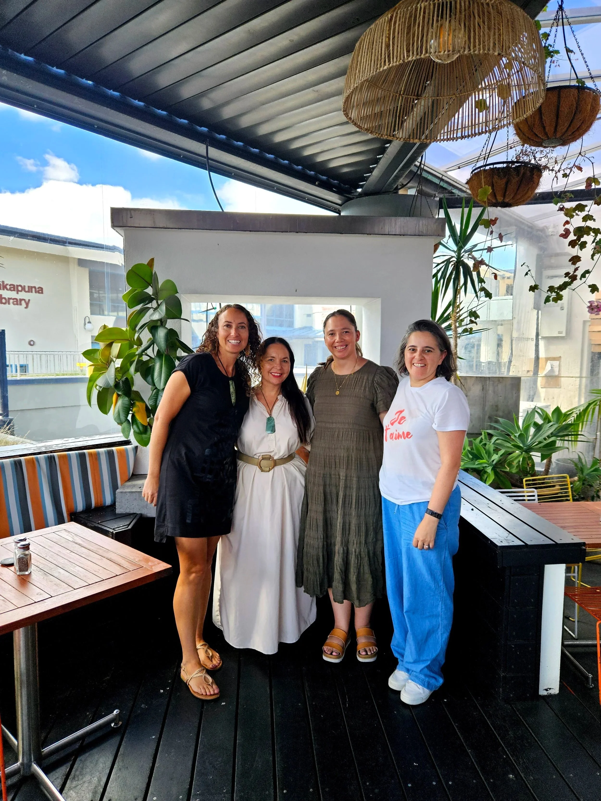 Four wāhine Māori standing together in a cafe