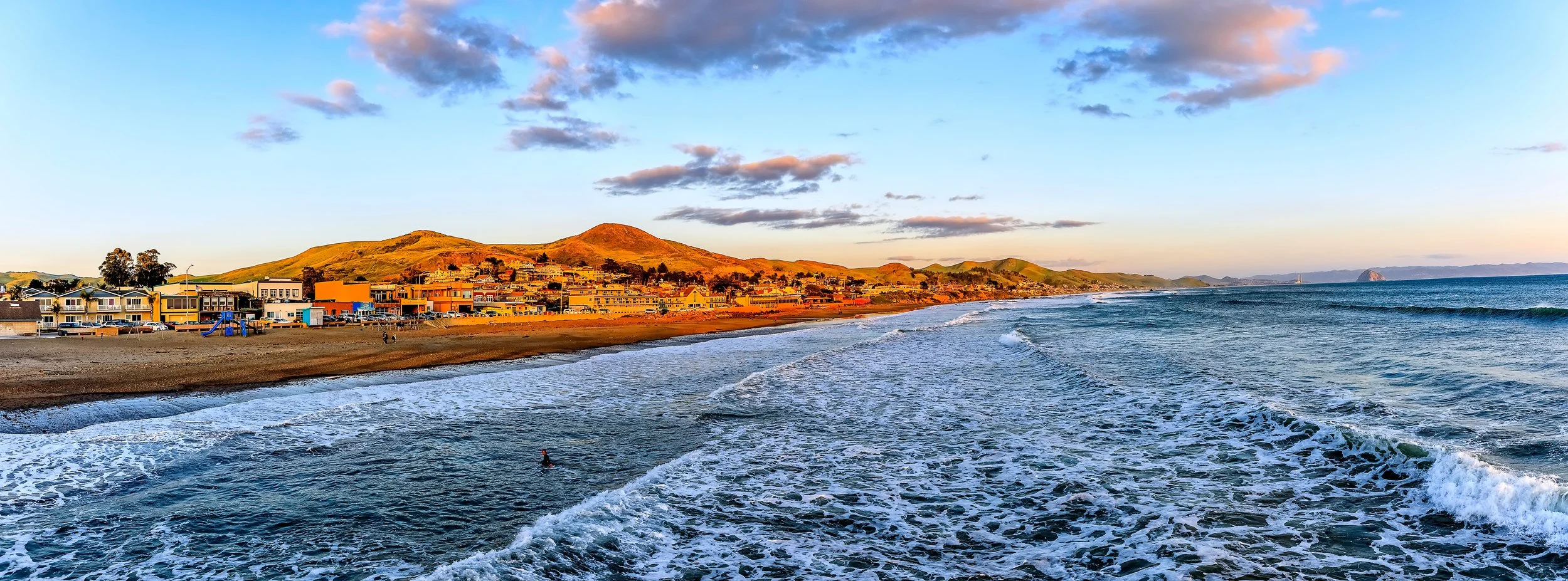 Cayucos Beach with Cayucos Downtown. Kestrel Landscapes Inspiration. View of Hidden Kitchen Cayucos, Schooners and Good Clean Fun. By the Cayucos Pier
