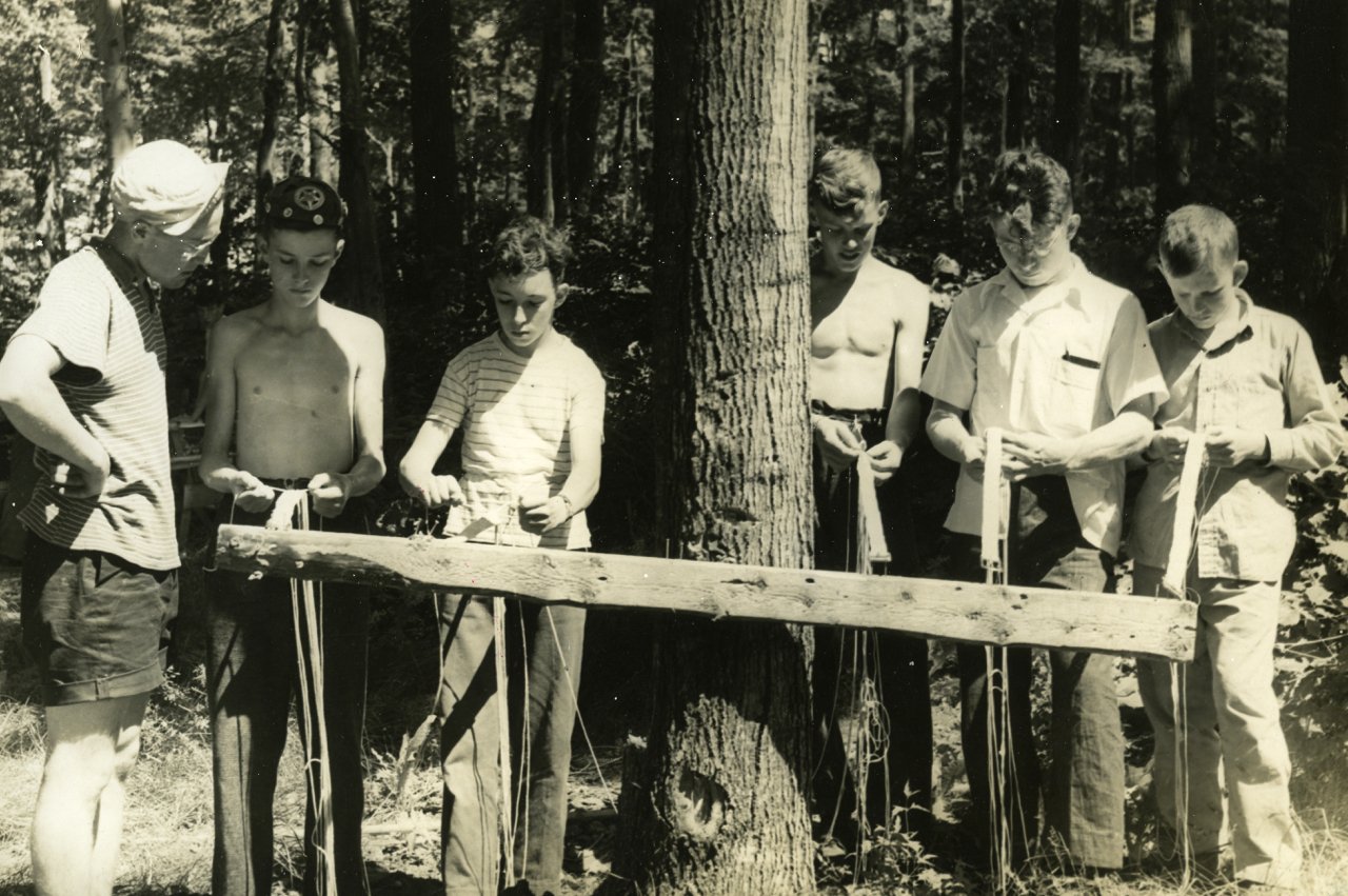 One of the activities at boys' camp was belt weaving. The weaving pattern was so complicated that it would take working on it every day for the full camp to complete. The Counsellor at the far left is Wayne Poapst. The smallish lad in the centre was 