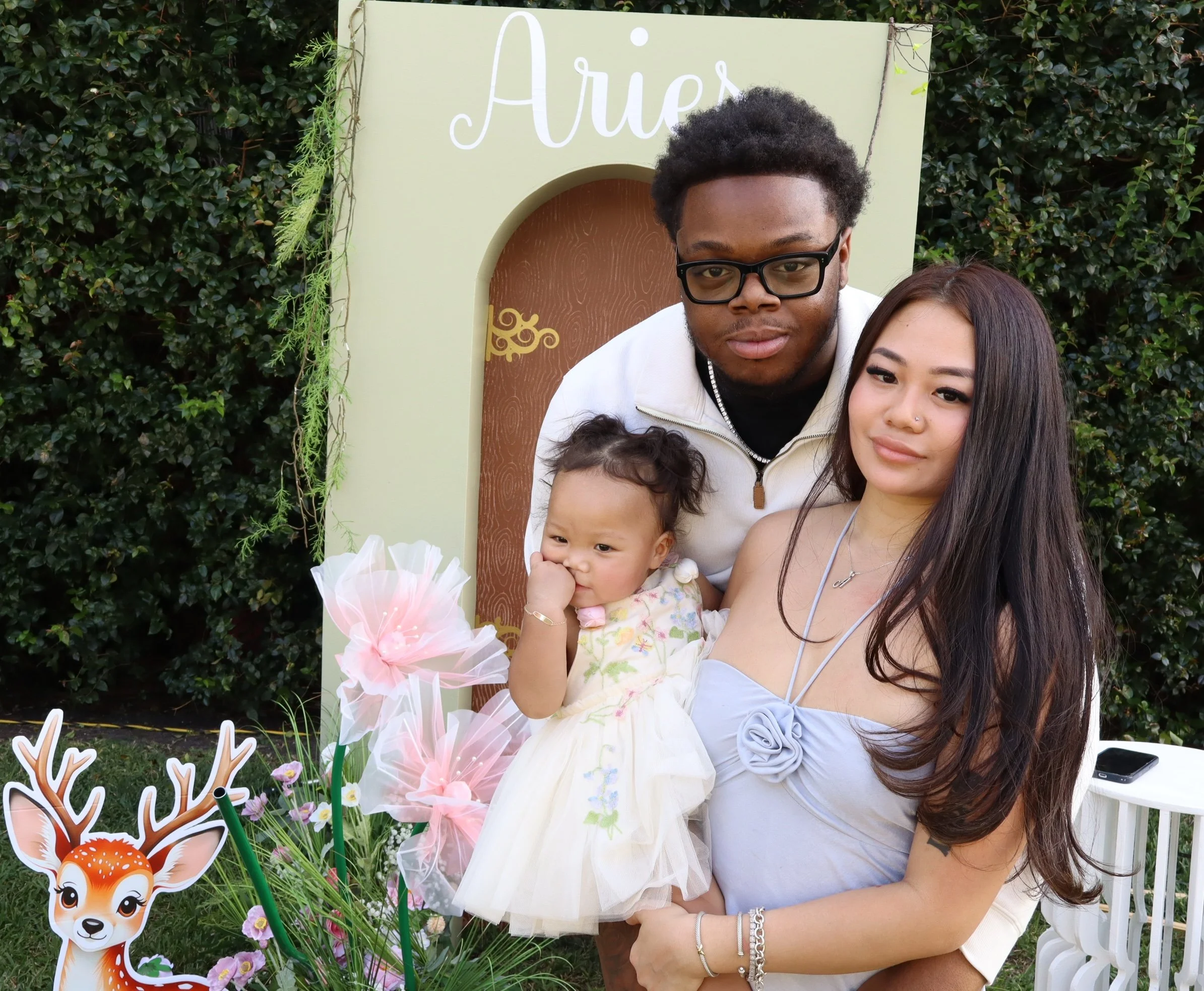 Family posing at first birthday at outdoor photo booth rental event in Fort Lauderdale, FL — D&amp;L Photobooths