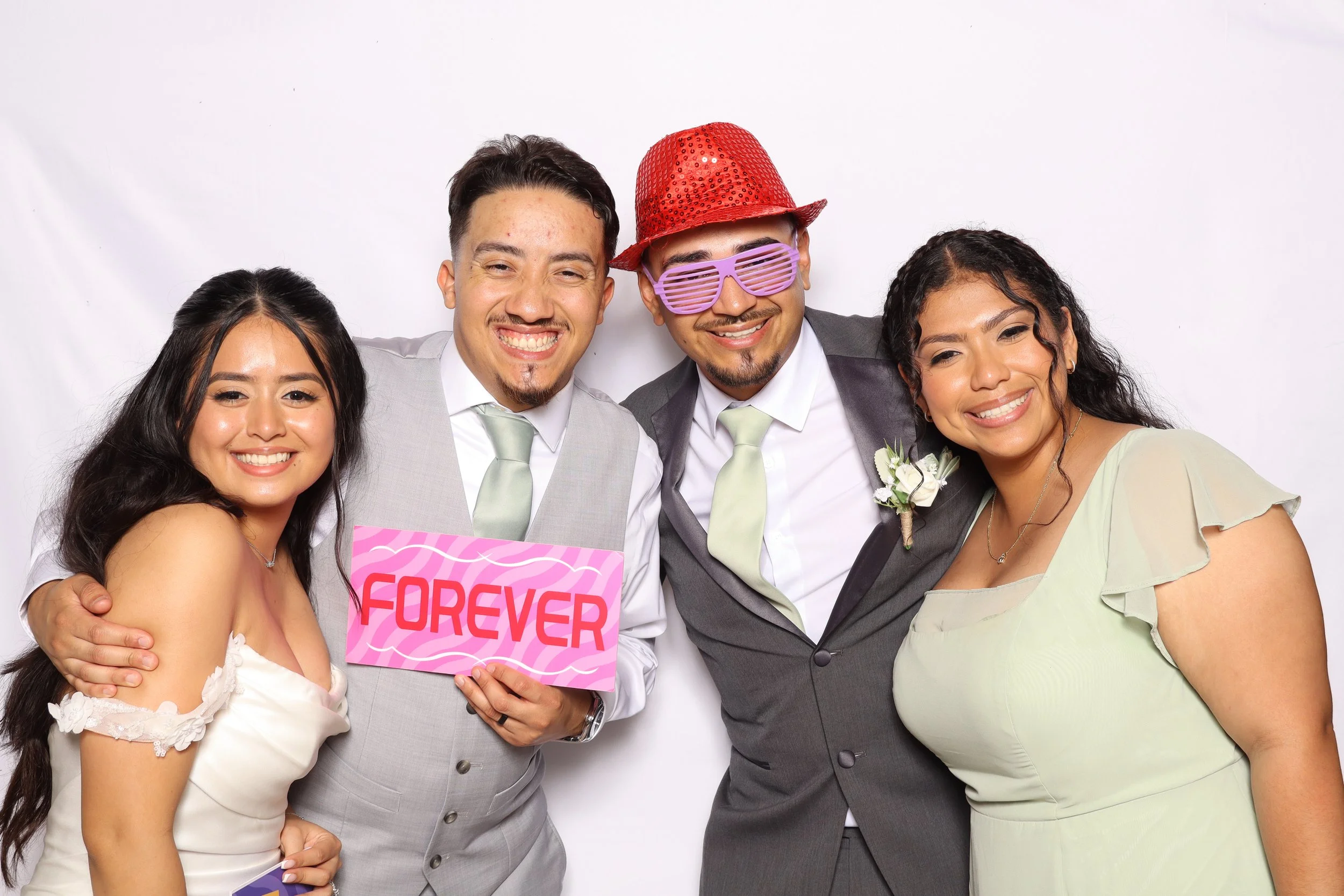 Wedding guests posing with Forever sign at photo booth rental in Vero Beach, FL — D&amp;L Photobooths