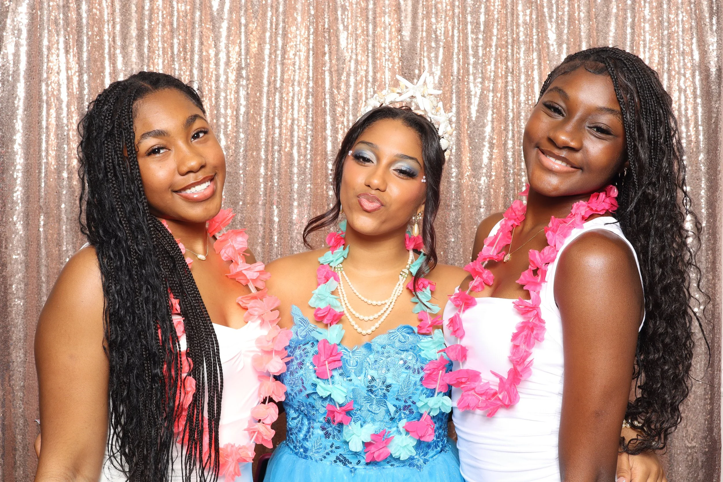 Three girls with leis and a tiara celebrating Sweet 16 at a rose gold sequin photo booth at photo booth rental in Greenacres, FL — D&amp;L Photobooths