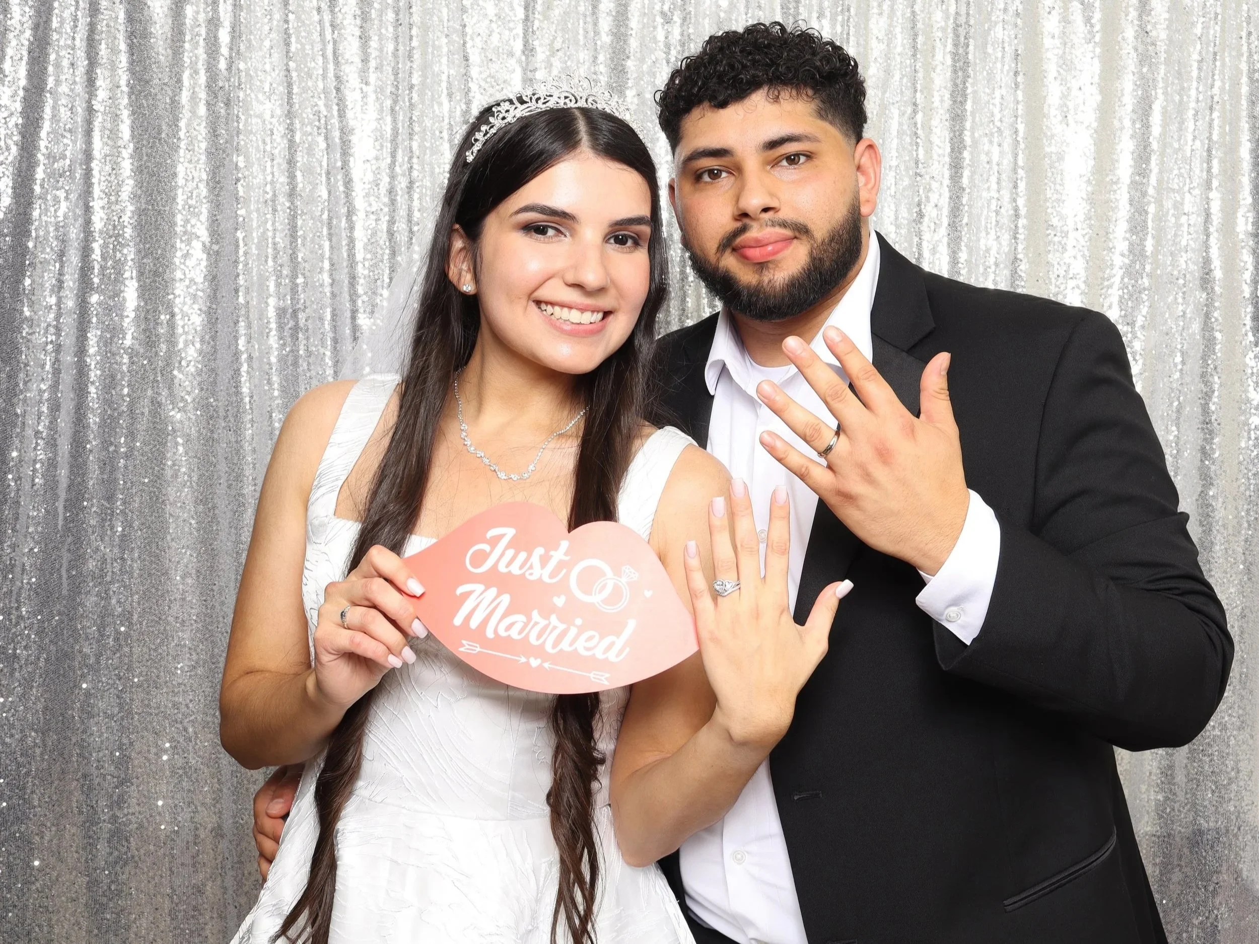 Just married couple holding a "Just Got Married" sign at a silver sequin wedding photo booth in Sunrise, FL — D&amp;L Photobooths