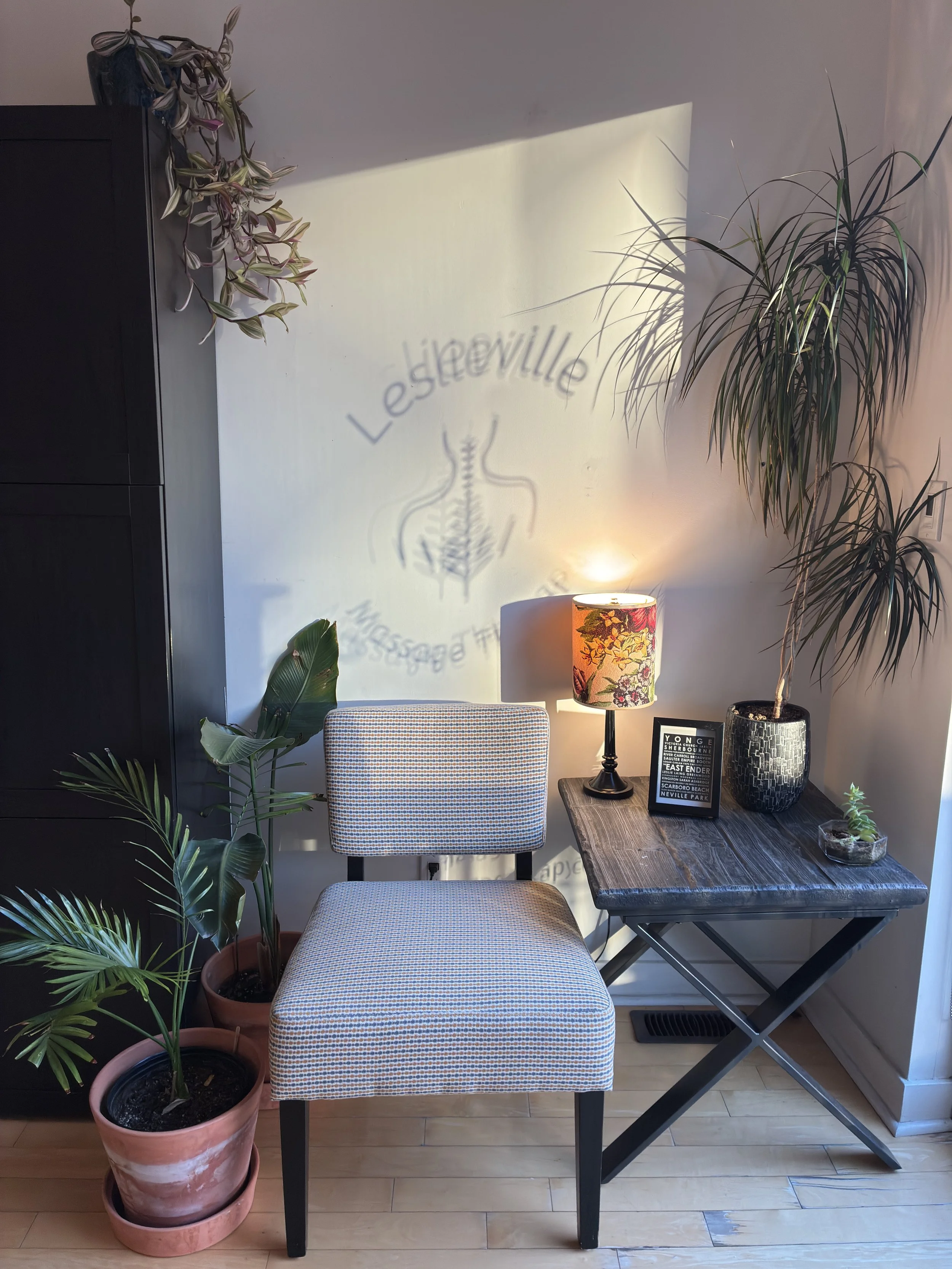 Sunlit seating area with plants at Leslieville Massage Therapy