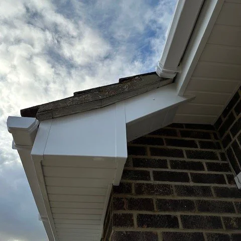 image showing the joinery of new white fascias and bargebaords with a birds mouth cut and white tongue and groove soffits